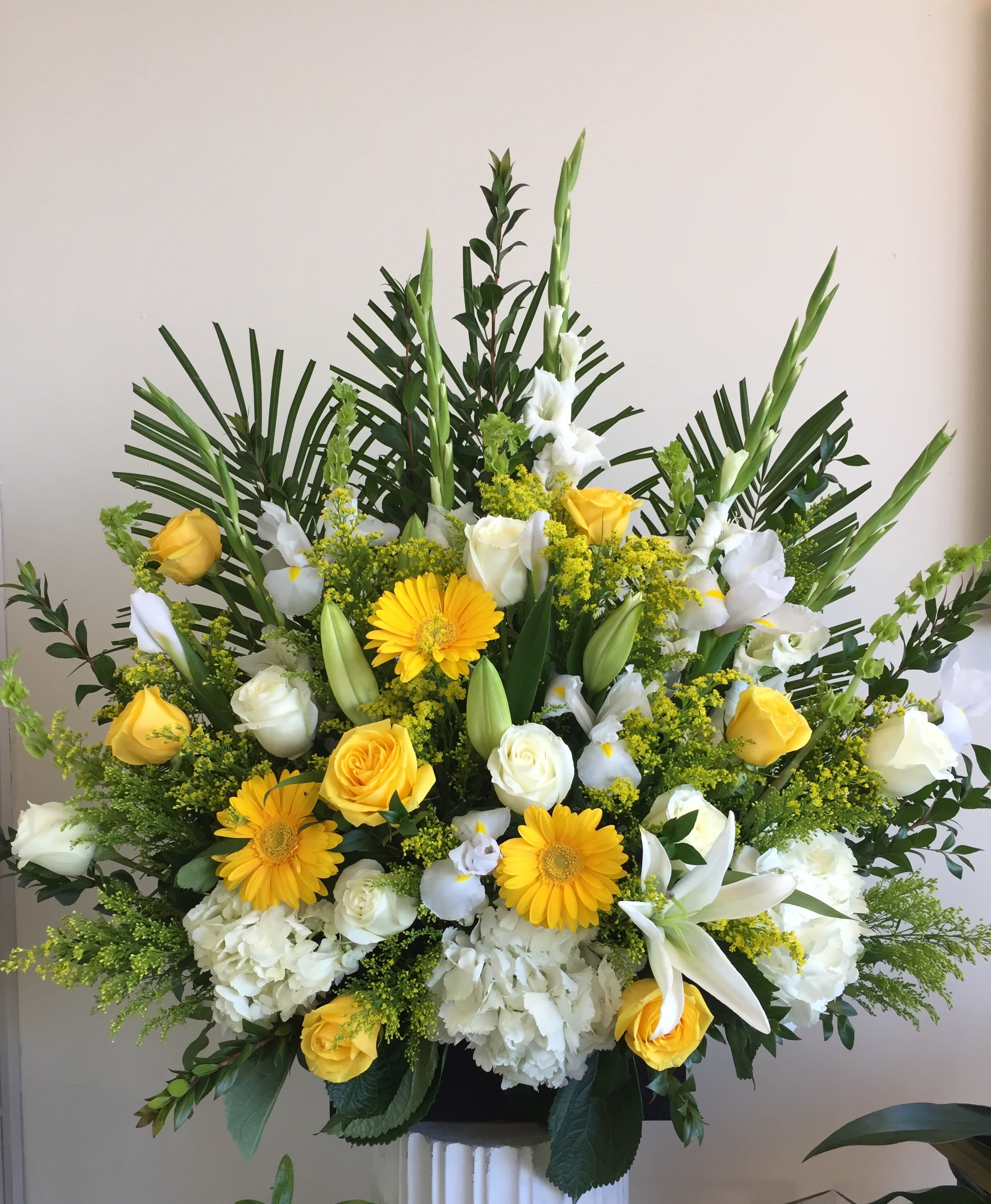 sunny day - Product Information Theme Colors: Shades of white, Yellow, and green  Arranged in a wooden box  Featured Blooms: Roses, Hydrangeas, Lilies, Gerbera, Iris, Gladiolus and greens  HK Flowers have a uniqueness of florals and seasonal blooms, certain flowers or colors may not be available as each season affects the availability, color, size, and shape of each floral bloom. Some flowers may be substituted accordingly.  Photos are used as a reference for the color palette and is NOT indicated of the final product. We ask for your trust in us that we will pick out the best seasonal available blooms, while still capturing the arrangements' theme and colors mentioned above.