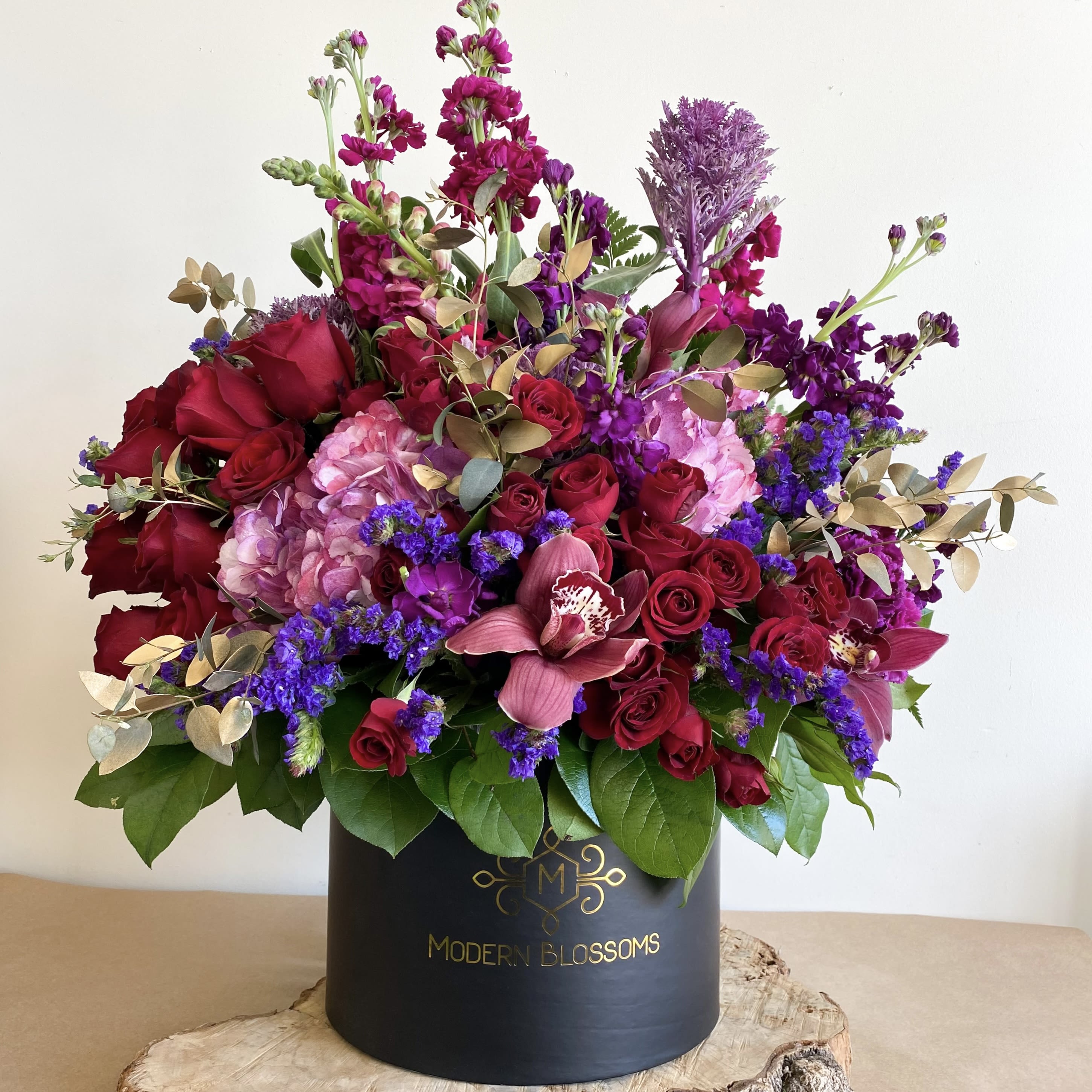 Symphony of Love - Product Information The hints of red roses are classic within these mums that symbolize optimism This arrangement is the perfect gift to show that forever love to someone special.  An arrangement Roses, Orchid, Stock, Hydrangeas and greenery in a black box.   Occasionally, substitution of flowers, plants, or containers may occur due to local and seasonal availability. We take the utmost care to ensure the same style and color scheme of the arrangement is maintained using similar items of equal or greater value.  The Arrangement and Vase may look different   The arrangement that is delivered contains the same number of flowers, but they are arranged throughout the entire vase. The vase shown may be out of stock. For the arrangement the look, style and color may be different from what is pictured.  To ensure the freshest flower delivery, certain flowers may arrive in their bud stage. This increases your flowers’ shelf life so you can enjoy them longer. Please allow 2-3 days for the flowers to reach full bloom.