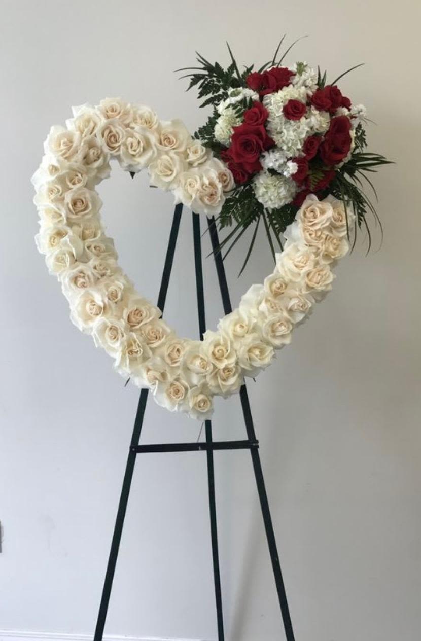 white heart shape funeral standing flowers - Theme Colors: Shades of white and green  Featured Blooms: Roses, Hydrangeas, and greens Heart shape funeral standing flowers.   HK Flowers have a uniqueness of florals and seasonal blooms, certain flowers or colors may not be available as each season affects the availability, color, size, and shape of each floral bloom. Some flowers may be substituted accordingly.  Photos are used as a reference for the color palette and is NOT indicated of the final product. We ask for your trust in us that we will pick out the best seasonal available blooms, while still capturing the arrangements' theme and colors mentioned above.