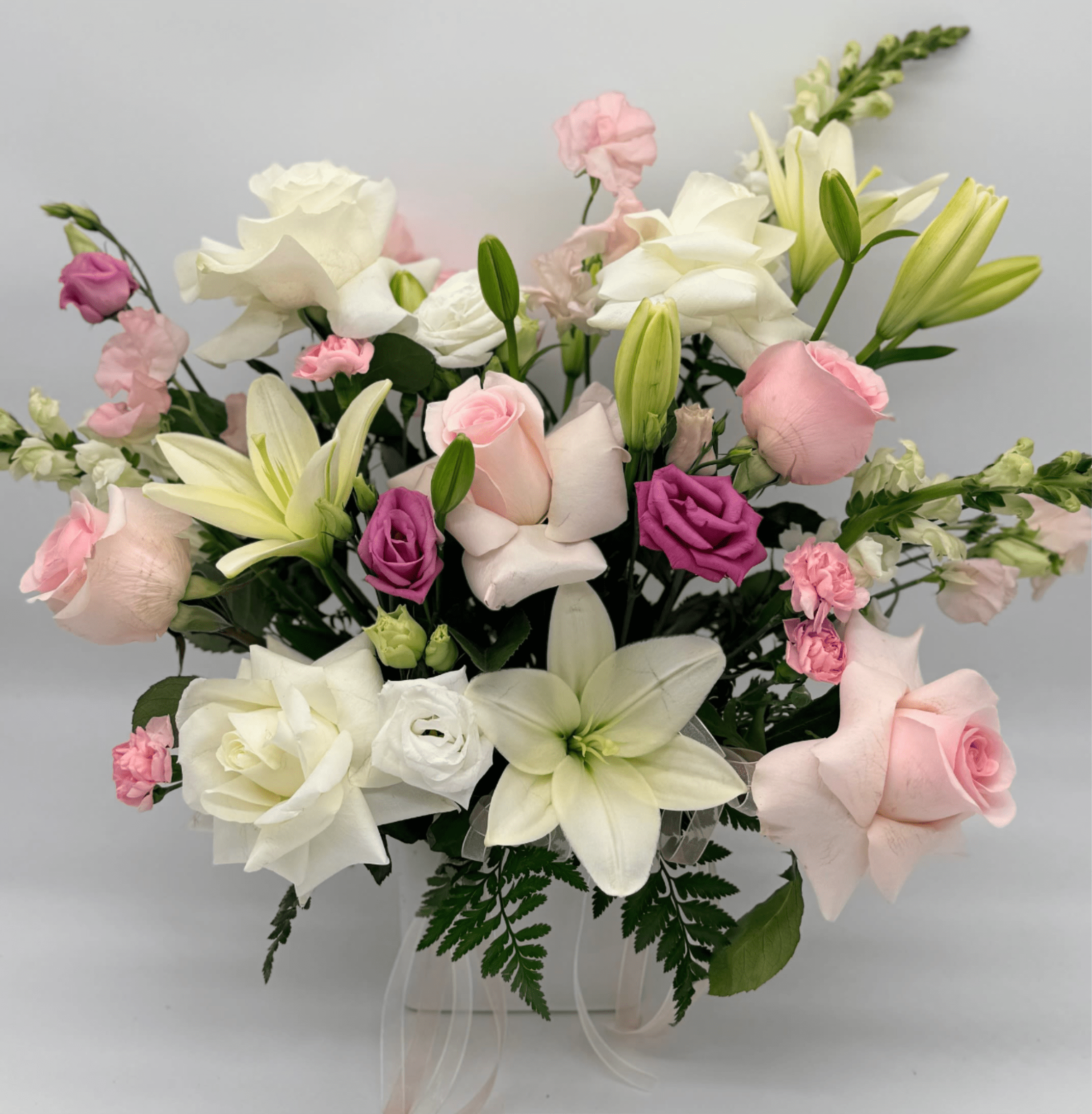 Designer's Choice - Ceramic Vase - A ceramic vase filled with seasonal blooms, thoughtfully designed by our designer. Vase color and style will vary and may include white, black, gold, hot pink, or other curated tones. Flowers and overall design are selected by the designer for a one-of-a-kind arrangement.