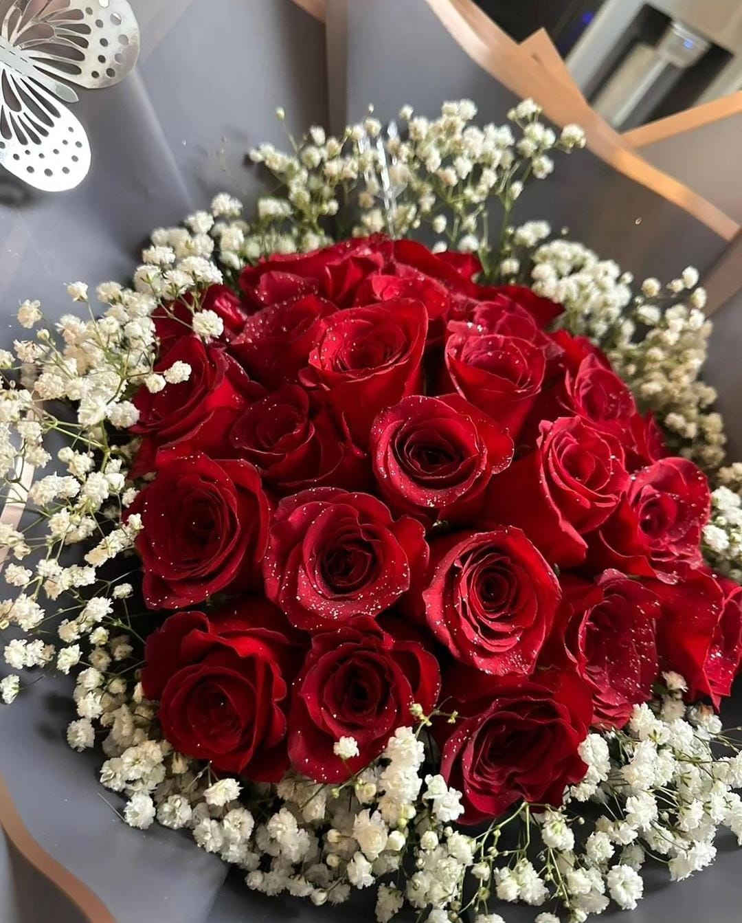 Baby Red - Twenty-five stunning red roses with baby's breath wrapped in black paper.