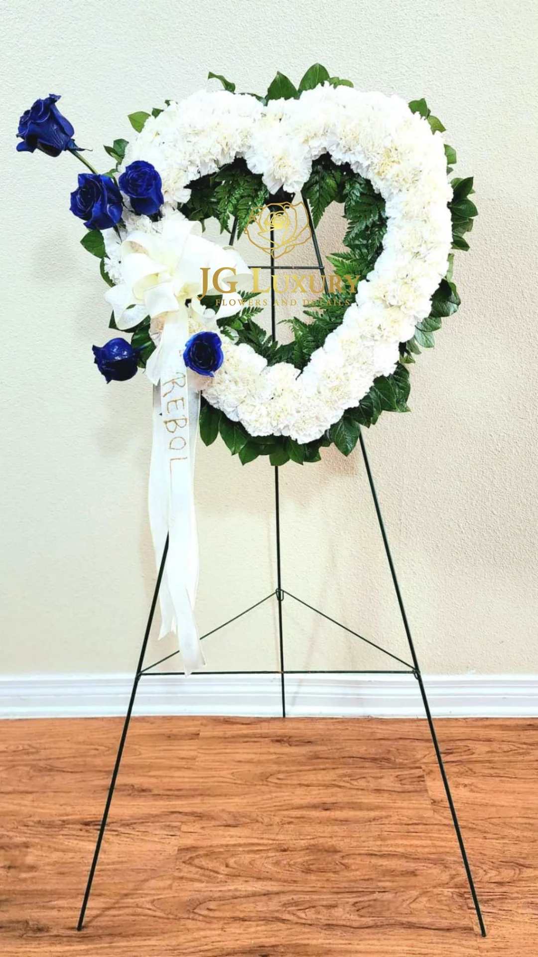 Blooming Blue - White carnations with blue roses and salal tips.