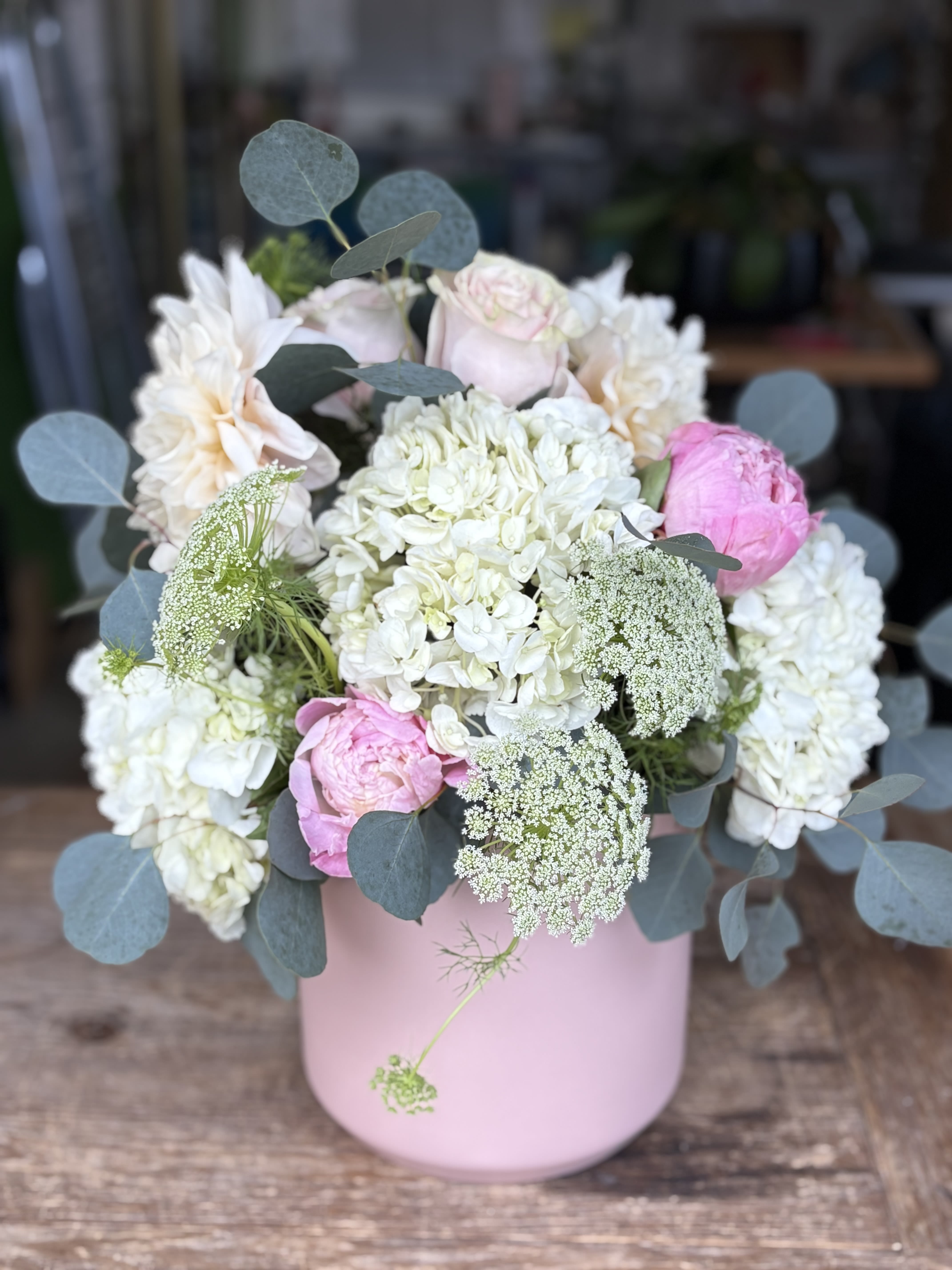 Cotton Candy Love - Hydrangea, Roses, Peonies, Queen Anne's Lace and Silver Dollar Eucalyptus in a Custom Rosey Ceramic Pot.