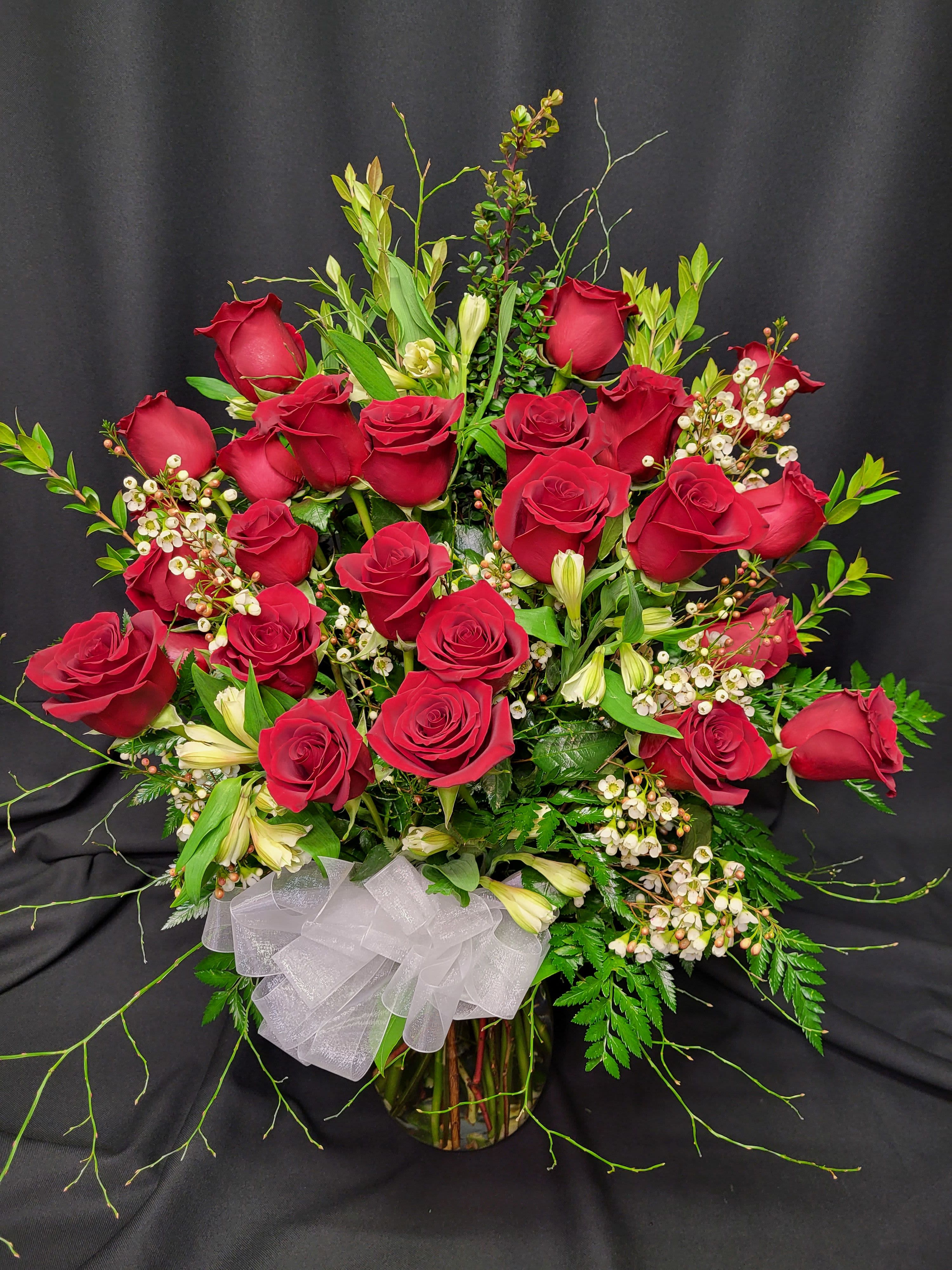2 Dozen Red Long Stem Roses - or Choose Color - Red Dozen unless 1) Red is unavailable due to shorter than 48 hour notice on your order &amp; we will notify you if this is the case or 2) You Choose Colored.  Our premium vased dozen includes filler flowers, lush greenery a gorgeous bow and quality vase. We deliver our roses completely arranged so there is no fuss to find scissors. All of this is included; there are no hidden costs for the best, most perfect roses you will find. Vase, filler flowers and greenery may vary.  The roses we carry are Colombian roses and Ecuadorian roses, which are much bigger than red California roses.