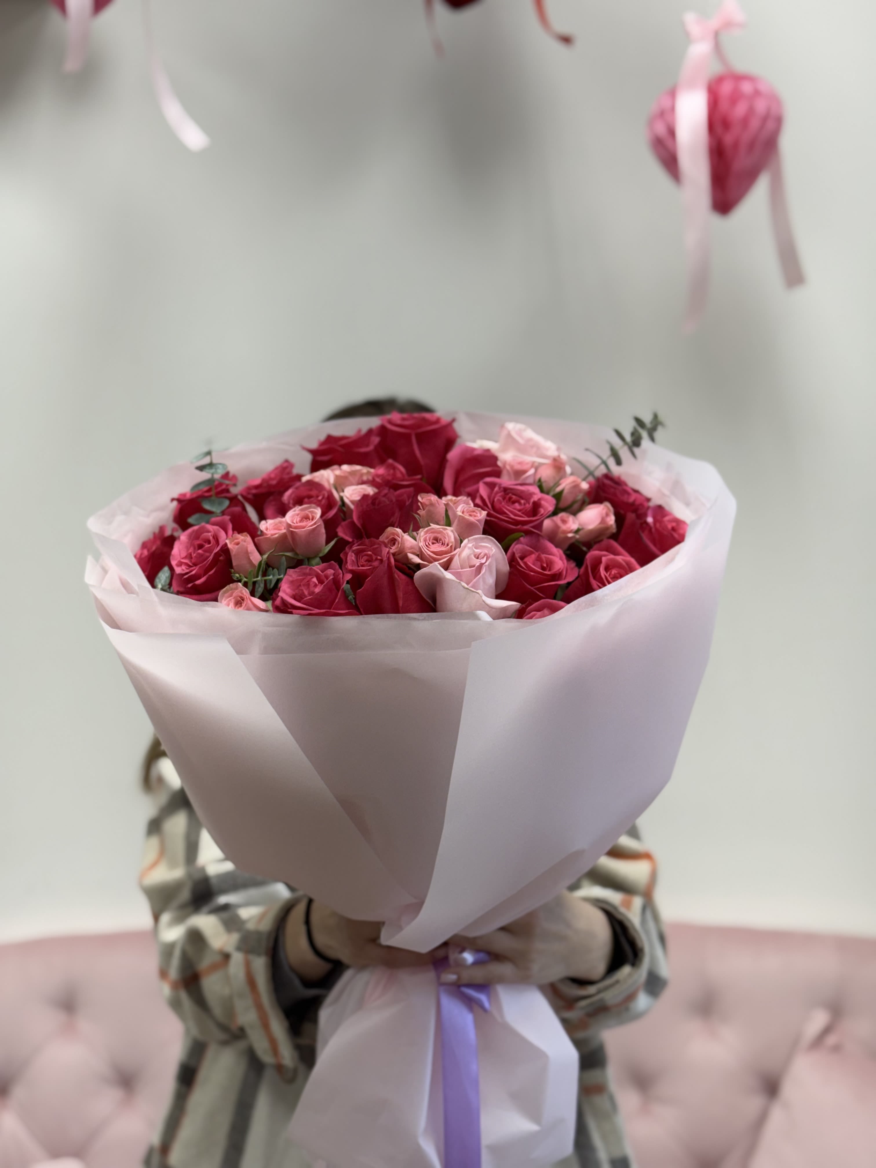 Pink Whisper - A romantic bouquet of rich fuchsia roses paired with delicate blush spray roses and fresh eucalyptus accents (20 stems).  Wrapped in soft pastel paper, Pink Whisper is a perfect balance of passion and tenderness. This bouquet speaks without words — ideal for birthdays, anniversaries, or simply to say “you are loved