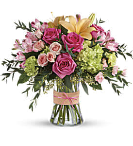 Blush Life Bouquet - Go ahead, make them blush! This luxurious bouquet of roses, lilies and hydrangea in fresh shades of pink, peach and green is sure to put some cheerful color in their cheeks! The delicate ribbons dress up the graceful keepsake vase. 