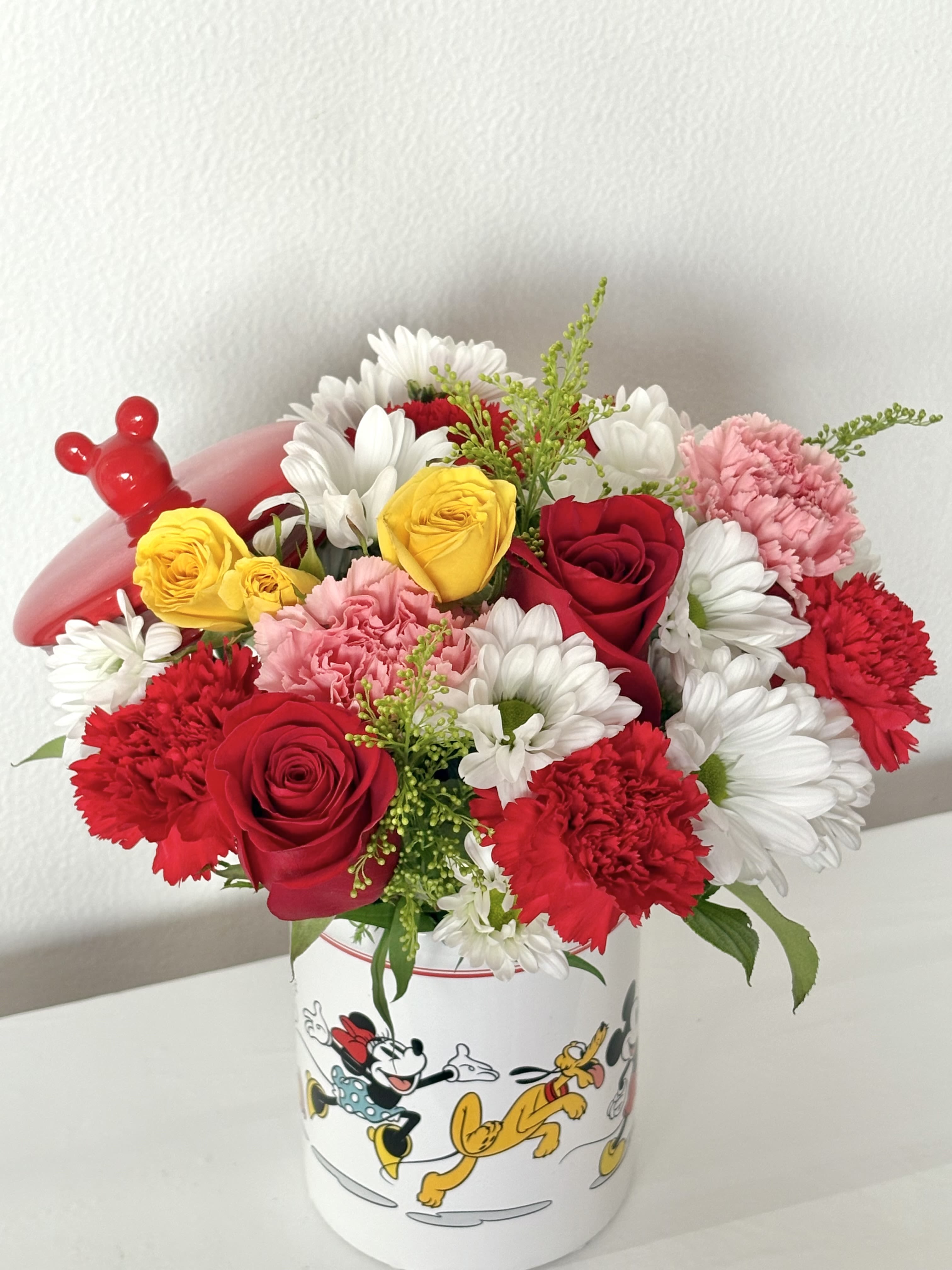 Disney Jar  - This 1800 flowers x Disney cookie jar is perfect to gift the Disney lover in your life. This jar contains all the characters and can be reused as a cookie jar! Measures approximately 14 inches. 