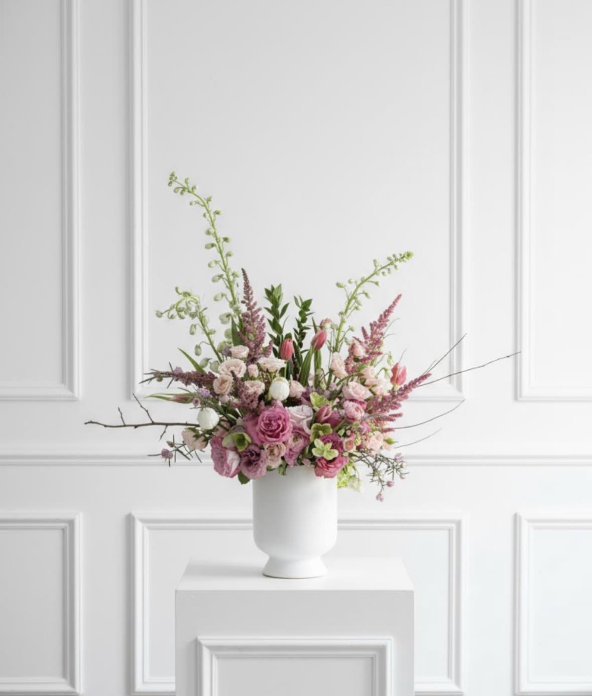 Petal Pink - A large and lovely display in shades of pink in a ceramic vase. The arrangement includes roses, tulips, ranunculus, lisianthus and more. A beautiful gift for any occasion but especially; Mother's Day, New Baby, Valentine's and more.