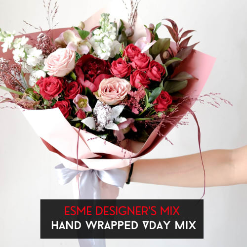 Hand Wrapped - VDay Mix Designer Choice - Designer's Choice - A selection of Valentine's Day mix of florist choice flowers, beautifully wrapped in our classic kraft paper with an elegant ribbon. Bouquet does NOT come in a vase and photos are for sample purposes only. Each bouquet will be a unique of its kind.   *Approximate pictured size is Deluxe