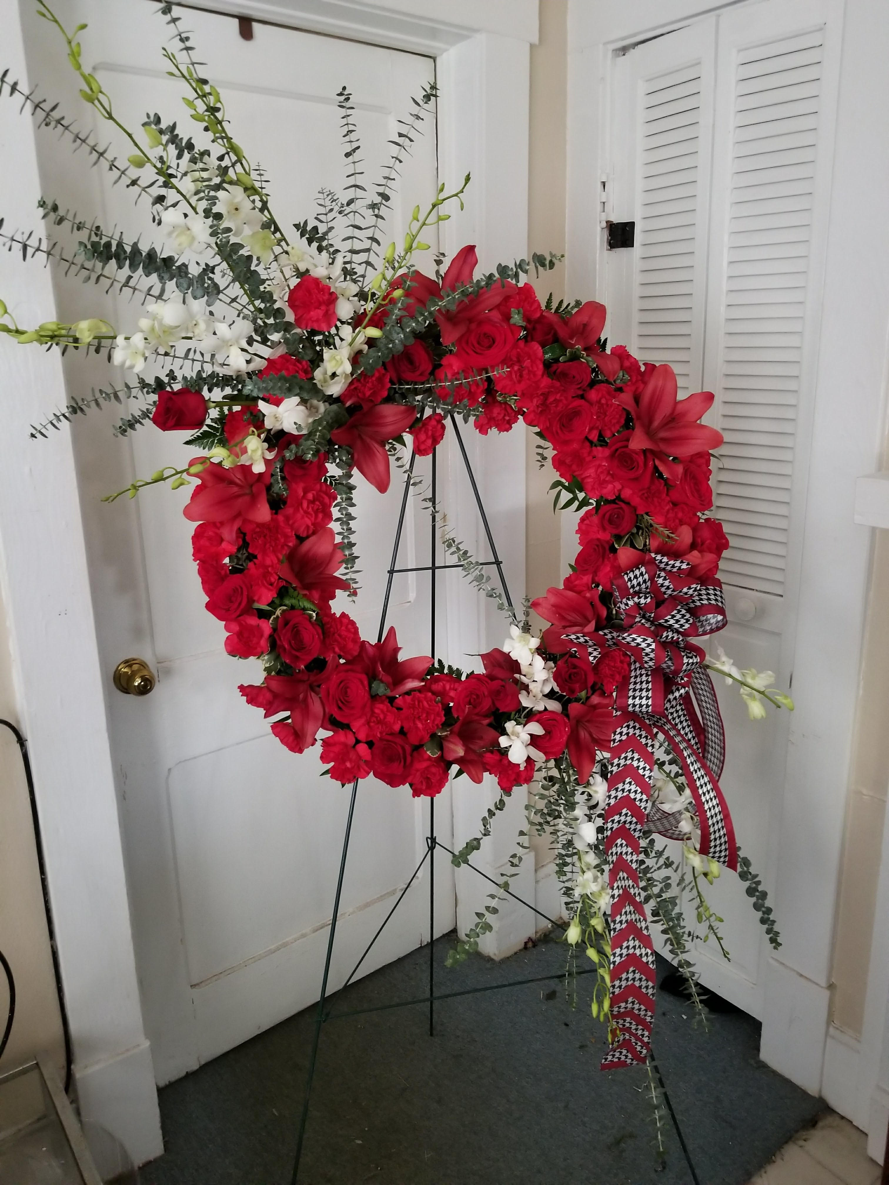 Roll Tide Wreath - A Die Hard Alabama Fan can appreciate this wreath with Orchids, Roses, lilies, and don't forget the Houndstooth Ribbon to add that finishing touch.  Love the concept, call us to create a Spray or Wreath with you favorite college Ribbon and Colors.