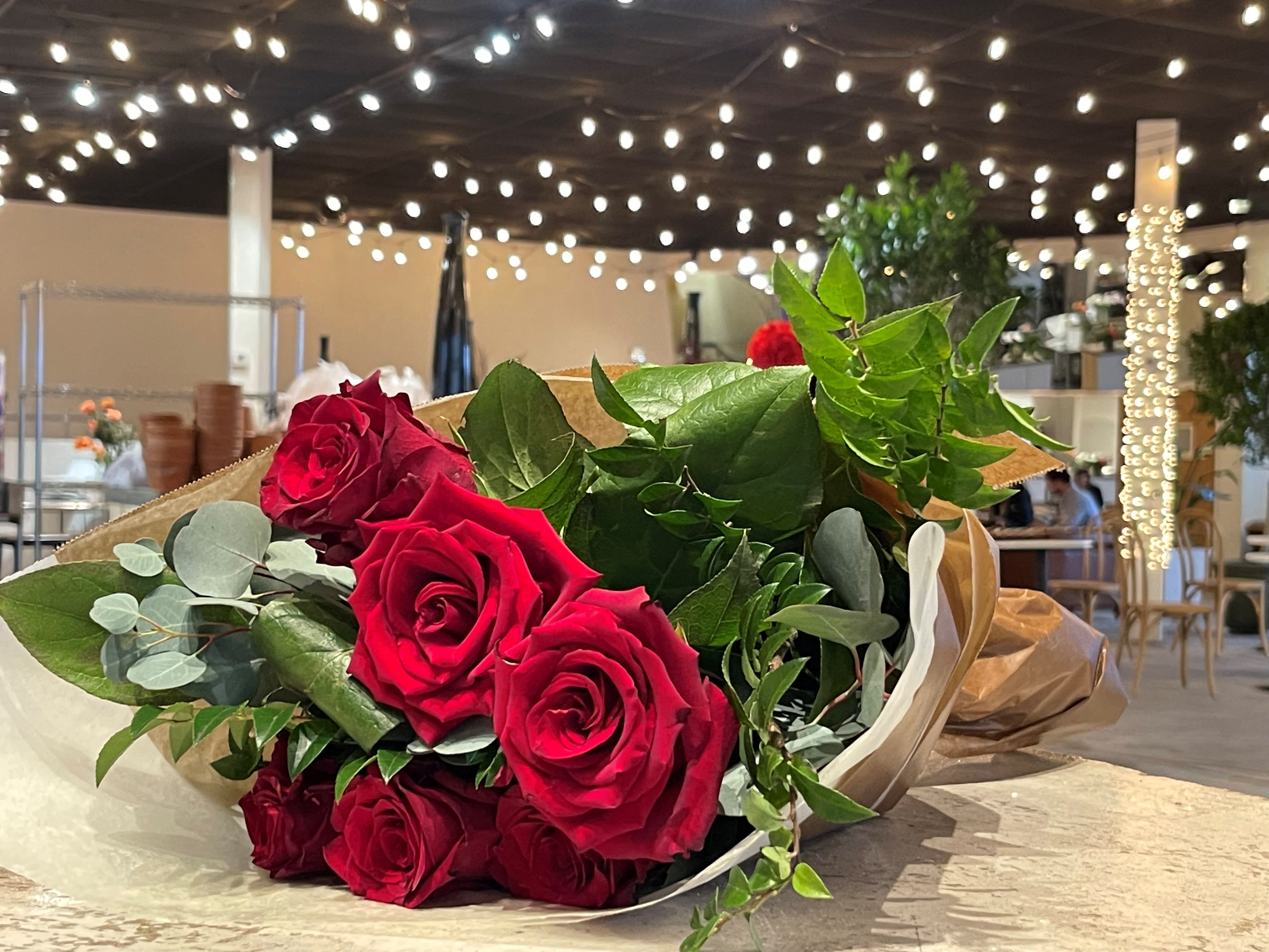 Bouquet Wrapped in Paper - Beautiful combinations of our 2023 Valentine’s Day flower pallet. With over 20 different blooms your bouquet is certain to impress. Some of our favorites: Kyiv (Ukraine) Clematis, Aarendelle Helleborus, Sugar Prince Tulips from Holland, &amp; of course, four unique and stunning varieties of red roses (heart roses, black magic roses, explorer roses &amp; freedom roses.)  