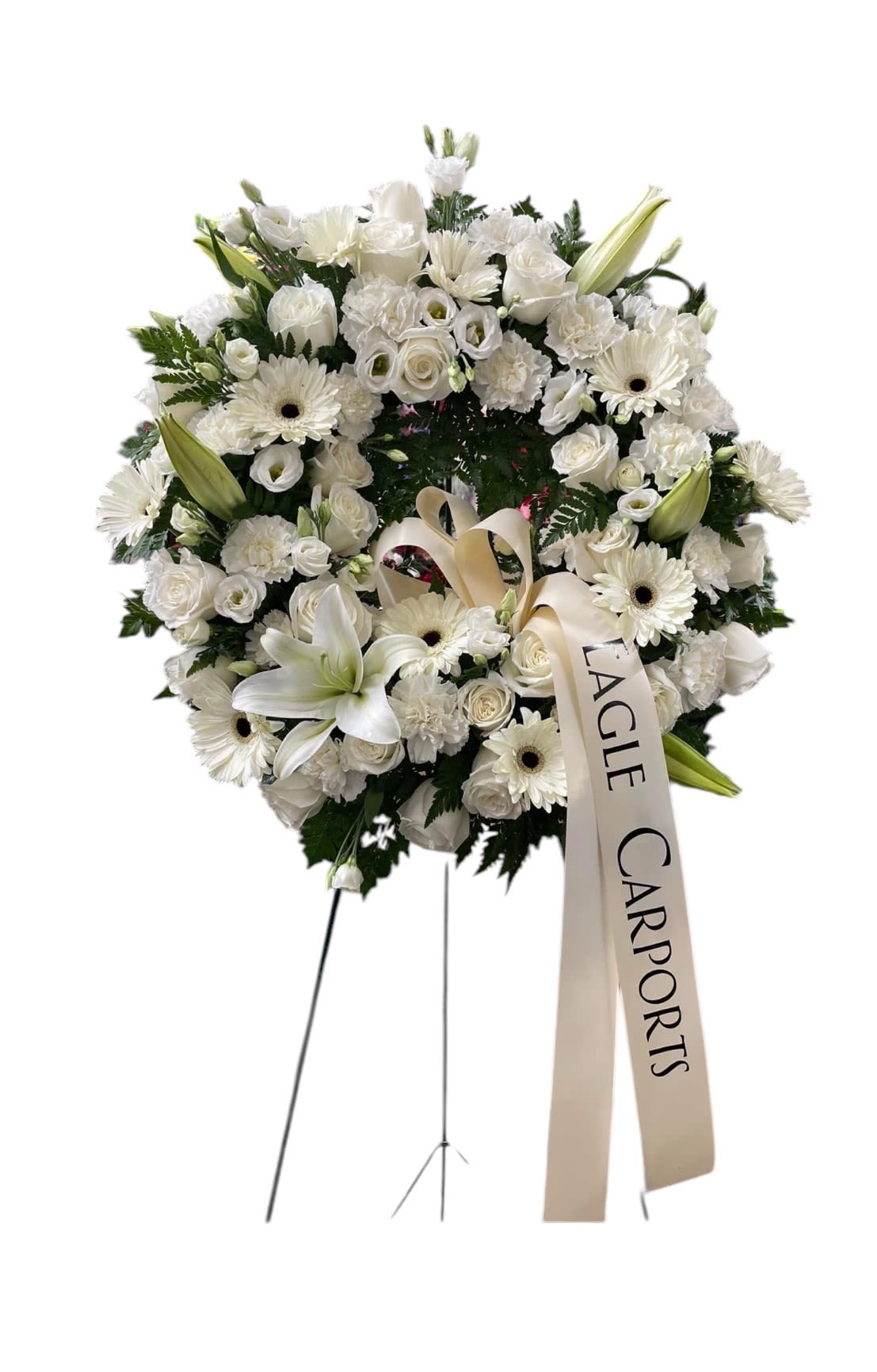 Pristine White Wreath - This pristine white wreath has all white flowers including Casablanca lilies, roses, gerbera daisies, carnations, and lisianthus