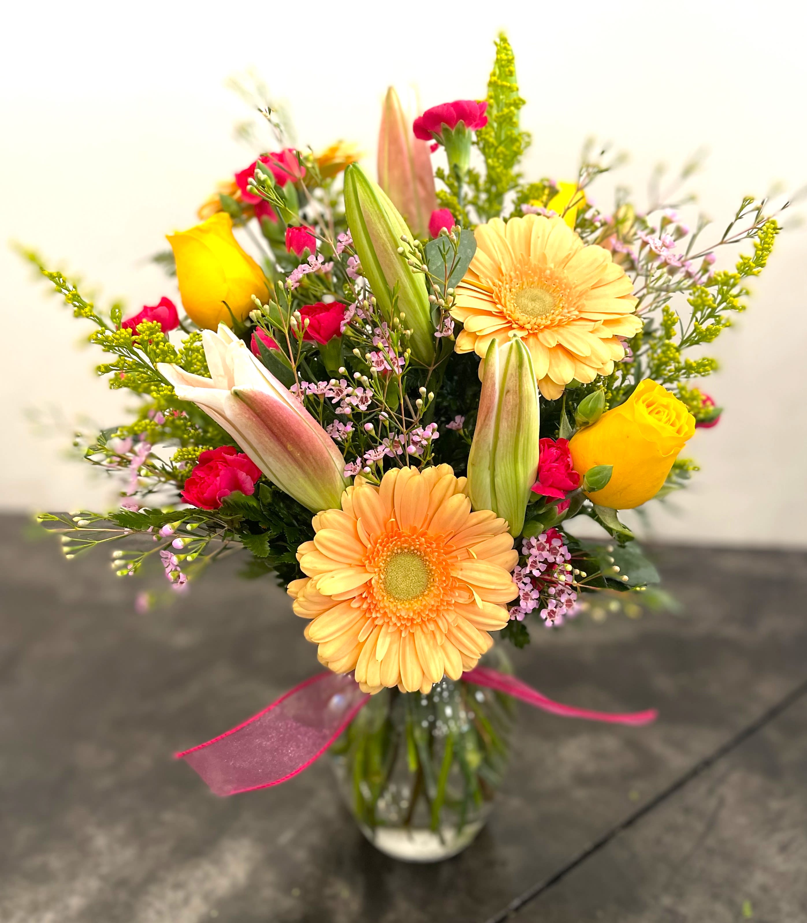 Love Sorbet - This awesome vase is packed with fresh oriental lilies, roses, fun gerbera daisies, pretty wax flowers, sunny solidego, and cute miniature carnations. It's like a burst of love sorbet