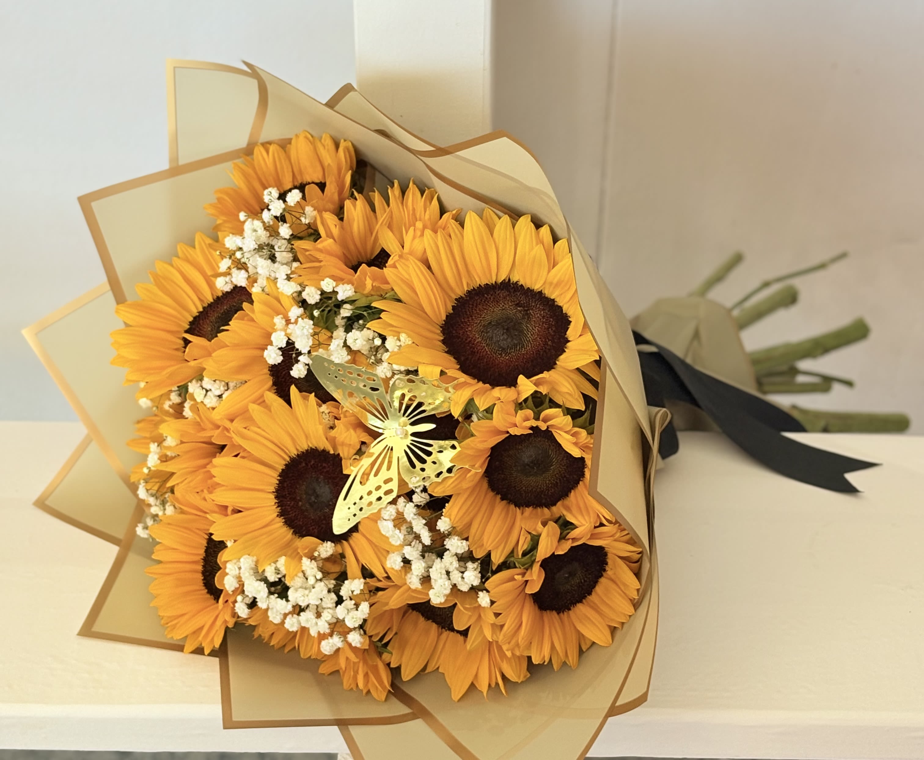 Sunflower Lover - An all around bright and beautiful bouquet for someone who loves sunflowers. Wrap color may vary due to availability. 
