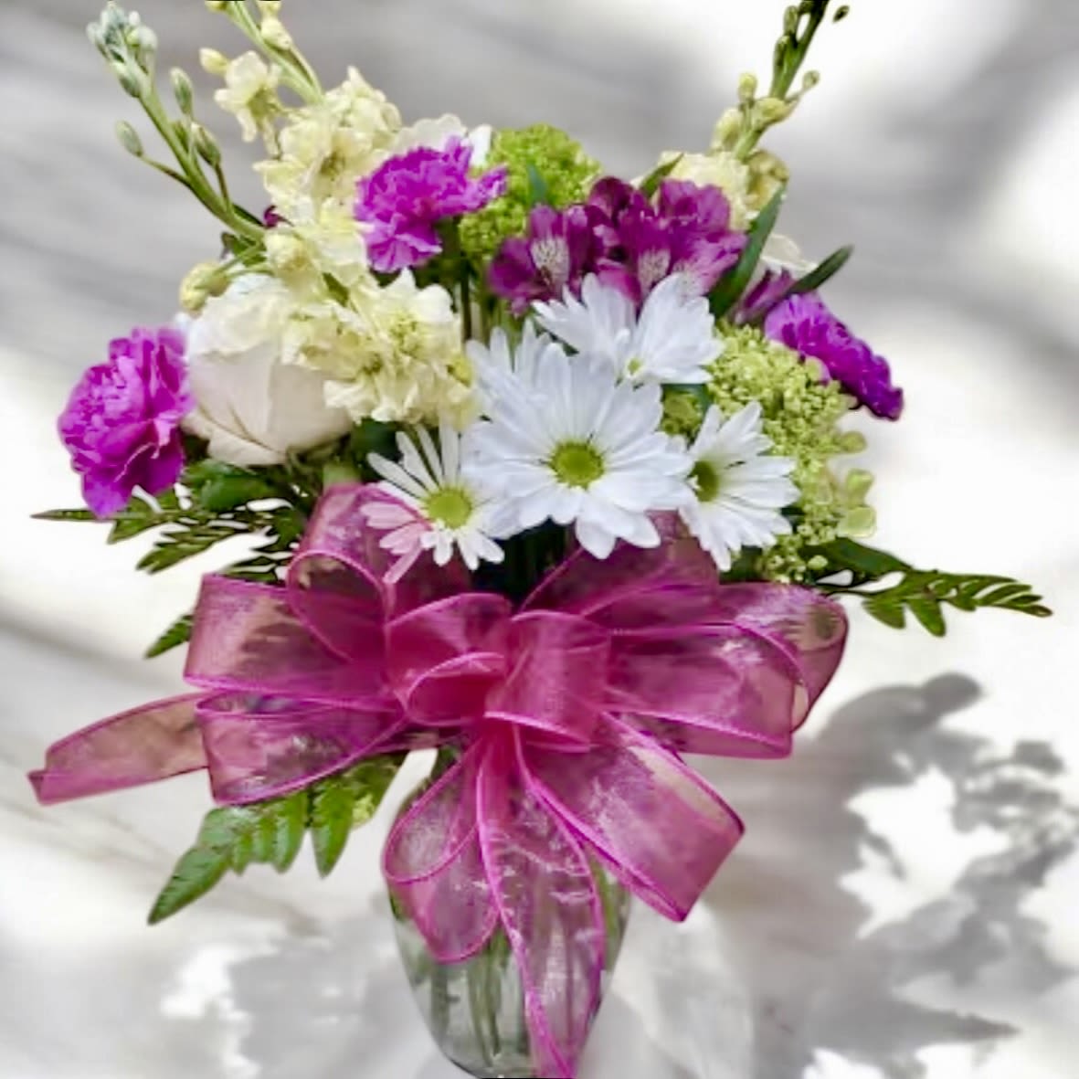 Spring Mix Vase - A bright beautiful spring mix of roses, carnations and alstroemeria in a glass vase.