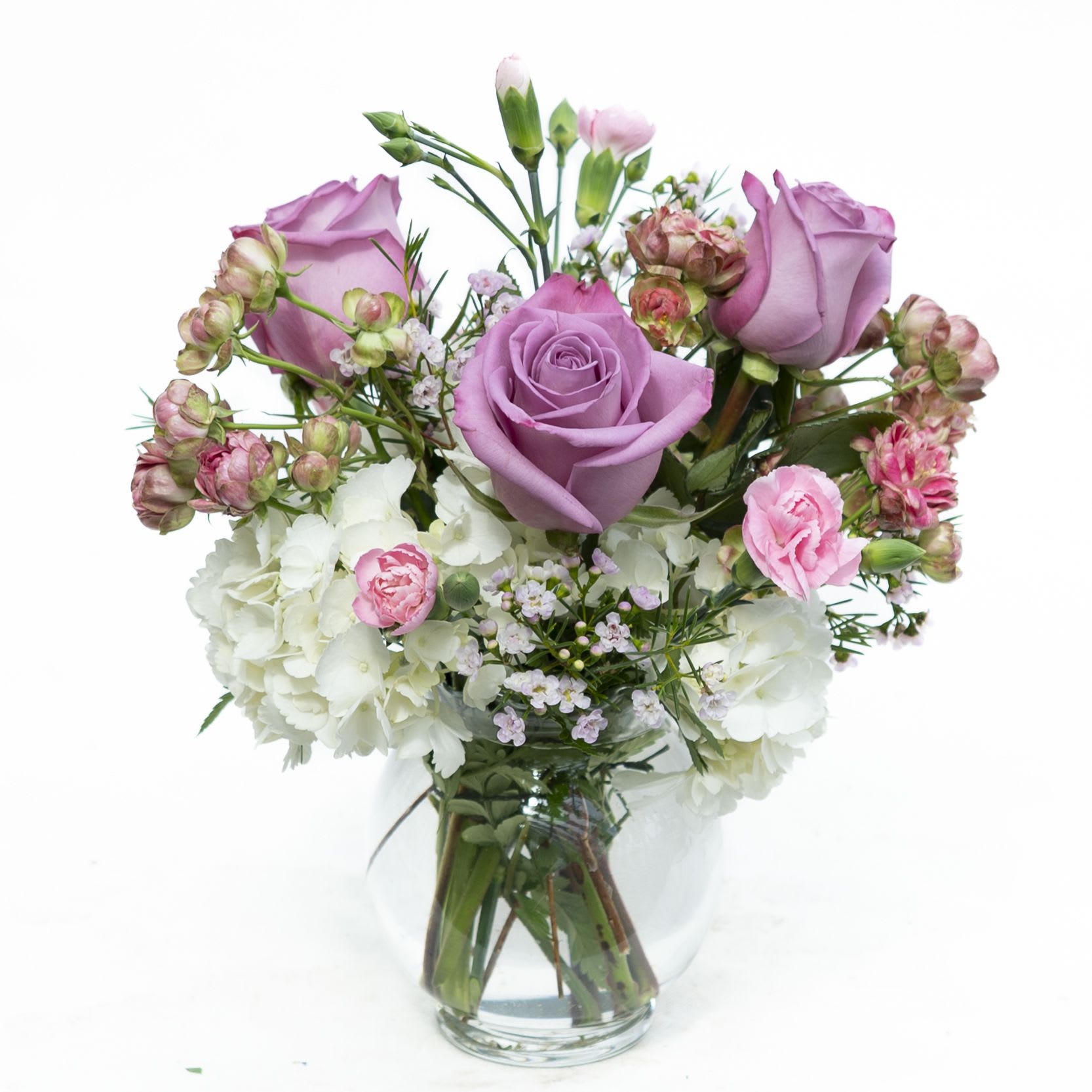 Spring Blooms B Pink - A sweet arrangement of Hydrangea, pink Spray Roses, lavender Roses, pink Mini-Carnations and Waxflower.