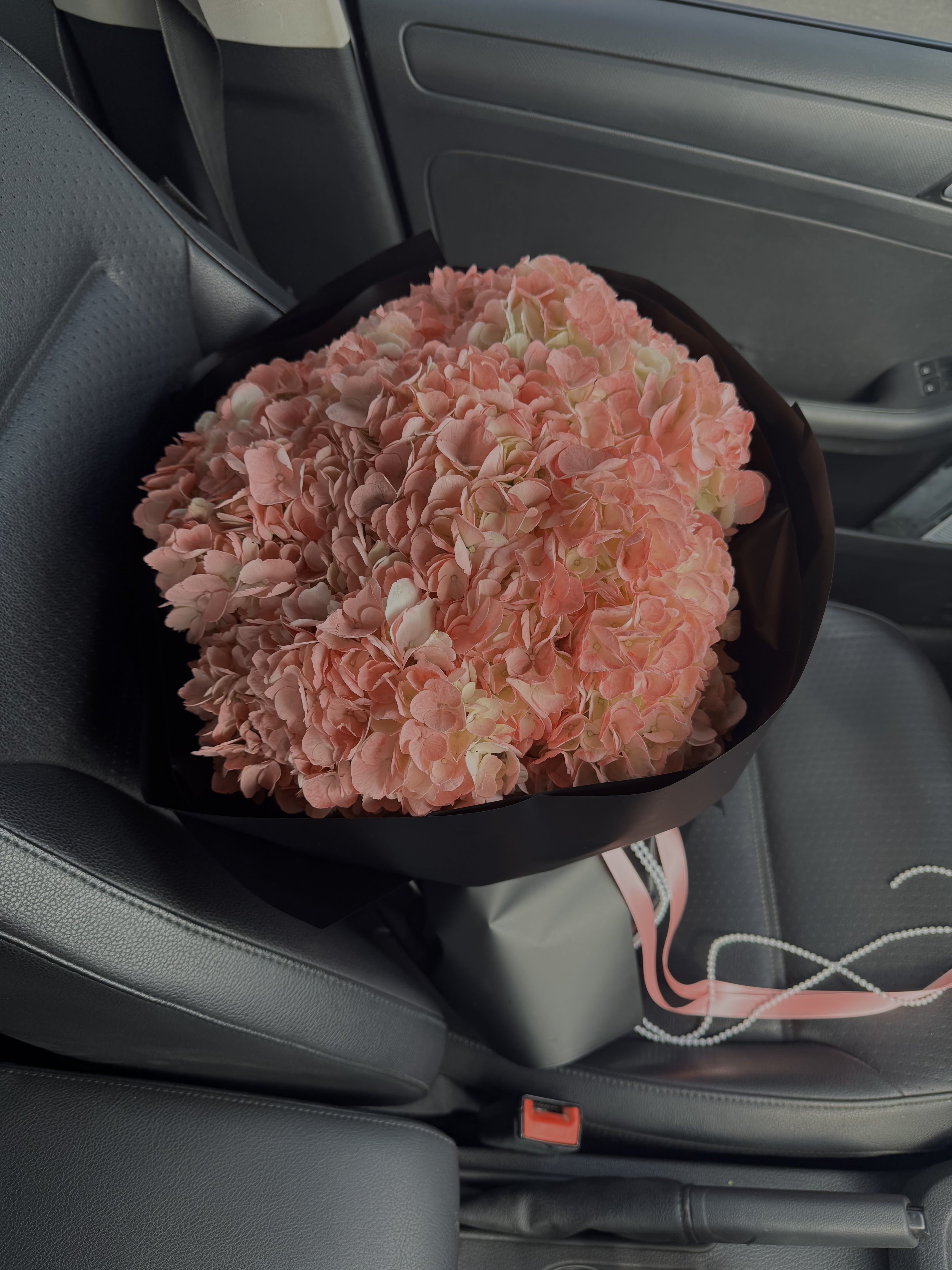 Bouquet of peach hydrangeas. - Peach hydrangeas in black packaging — tenderness and style in one bouquet  Imagine: soft, airy hydrangea inflorescences of a delicate peach shade, which seem to have absorbed the morning sun. Their velvet petals shine with warmth, creating an atmosphere of tenderness and comfort. And the contrasting black packaging gives the bouquet a sophisticated, bold and modern accent.  These are not just flowers — they are a finished work of art that will emphasize the taste and status of the giver.  ⸻  Why peach hydrangea? • A symbol of tenderness and harmony. Peach color is associated with warmth, care and romance. • Ideal for any occasion. Such a bouquet is equally appropriate for a wedding, birthday, anniversary or as a sign of sincere sympathy. • Airy texture. Hydrangeas create a voluminous, light and at the same time luxurious bouquet.  ⸻  This design option is ideal for those who want to give not just flowers, but emotions with an element of luxury.  Peach hydrangeas in black packaging - a gift that speaks without words  Give not just flowers, but emotions. Such a bouquet will become a symbol of tenderness, elegance and modern style.   Order right now - and surprise your loved ones with an exquisite gift that will be remembered for a long time. 