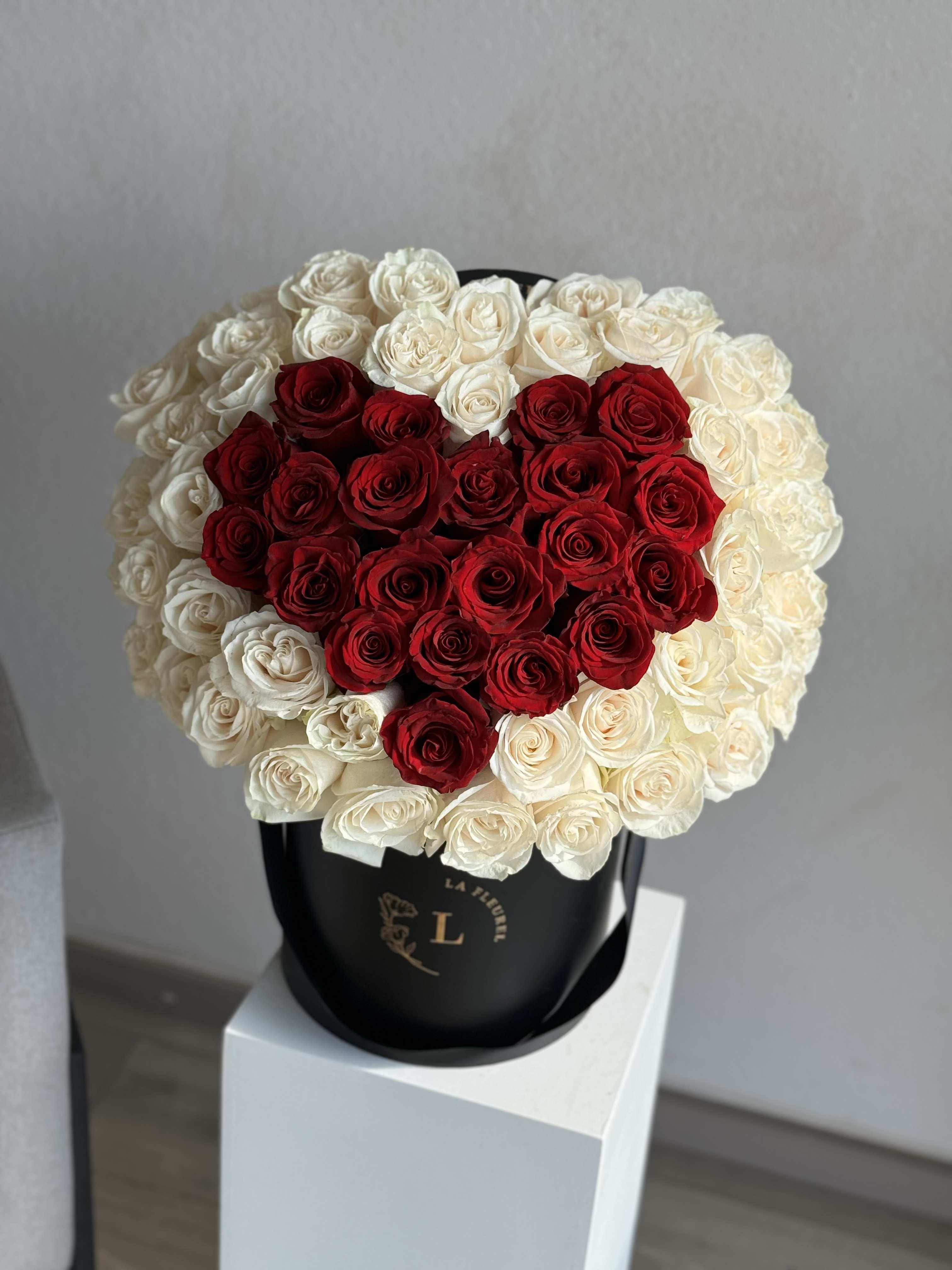 Lovely Heart Arrangement in a black box - This beautiful box contains a combination of 65-75 fresh roses in a black box. This floral arrangment is the perfect gift for your loved one!  Arrangement includes: Fresh red and white roses Custom greeting card