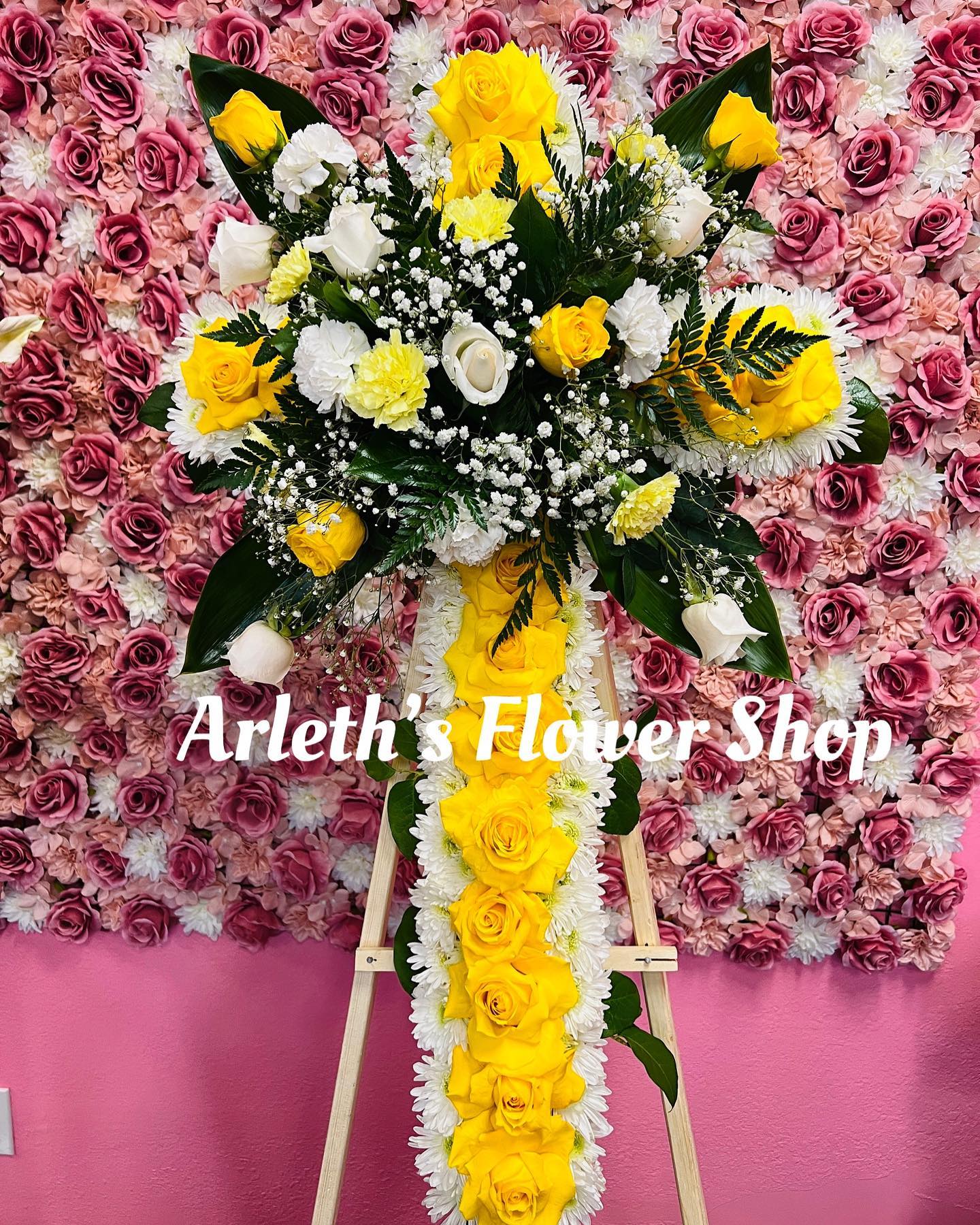 Medium Cross With Yellow Roses - This is a medium cross with yellow roses, white roses, and carnations.