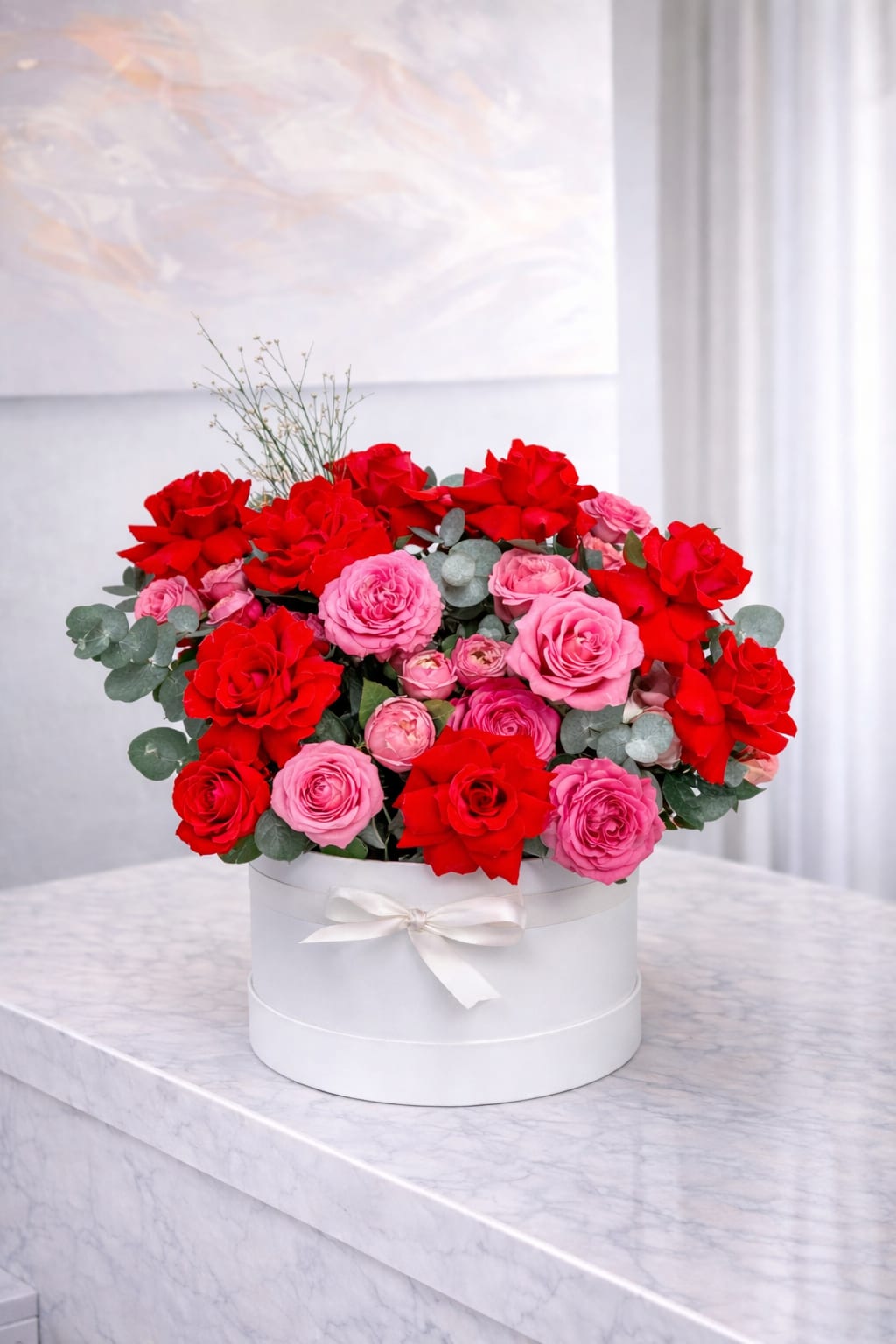 Rose Devotion - A luxurious arrangement of fresh red and pink roses designed in an elegant white hatbox, perfect for expressing love and admiration Ideal for anniversaries, birthdays, Valentine’s Day, or any special moment that calls for timeless elegance