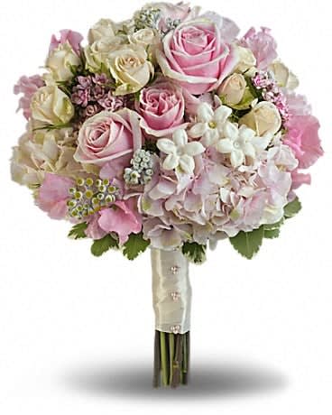 Pink Rose Splendor Bouquet - A wonderfully wide variety of soft pink and white blooms make this fragrant bouquet fabulously feminine. Sensational stems of pink hydrangea, light pink roses, crÃ¨me roses, pink sweet pea, pink bouvardia, stephanotis and dusty miller are contrasted against variegated pittosporum. 