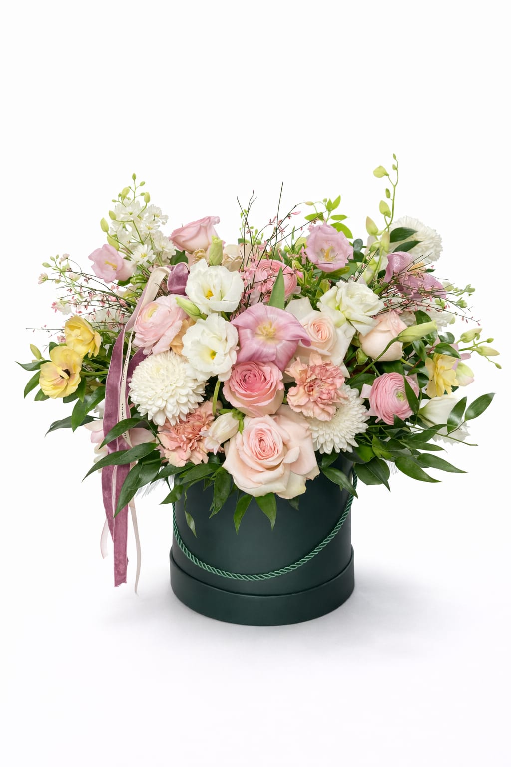 Blushing Box Garden  - Blushing Box Garden is a romantic, garden-inspired arrangement designed in our signature hatbox. Featuring a soft blend of blush and ivory roses, delicate lisianthus, ranunculus, carnations, and seasonal accent blooms, this arrangement is finished with lush greenery and elegant ribbon details.  Thoughtfully styled to feel airy, abundant, and effortlessly refined, Blushing Box Garden is perfect for birthdays, anniversaries, celebrations of love, or simply sending something beautiful “just because.” Each design is handcrafted by our florists, making every box feel fresh, intentional, and uniquely special.  Flower varieties may vary slightly based on seasonal availability while maintaining the overall color palette and style.