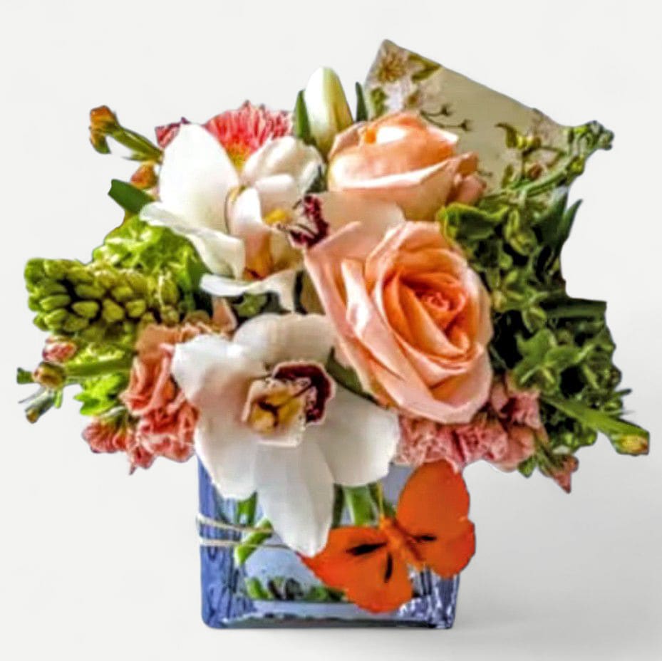 Vanilla Peach Designer's Choice - Roses orchids and more arranged in a modern glass cube style vase. Pretty and made extra special and unique each time. Perfect for every occasion to send a smile. Send happiness.