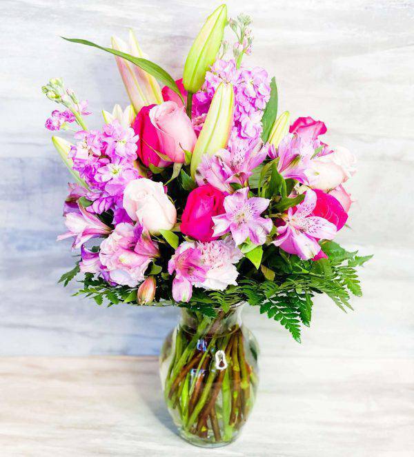 Modern Garden Bouquet - The Modern Garden Bouquet by DGM Flowers | Fort Lauderdale Florist is a stunning arrangement. This garden romance bouquet offers an unforgettable style for your recipient to adore. Including pink roses, pink lilies, daisies and stock, perfectly brought together in a clear glass vase. A beautiful presentation that makes an excellent gift for a birthday, anniversary, thank you, or any special occasion this season. Elevate your space with the Elegant Garden Bouquet today!