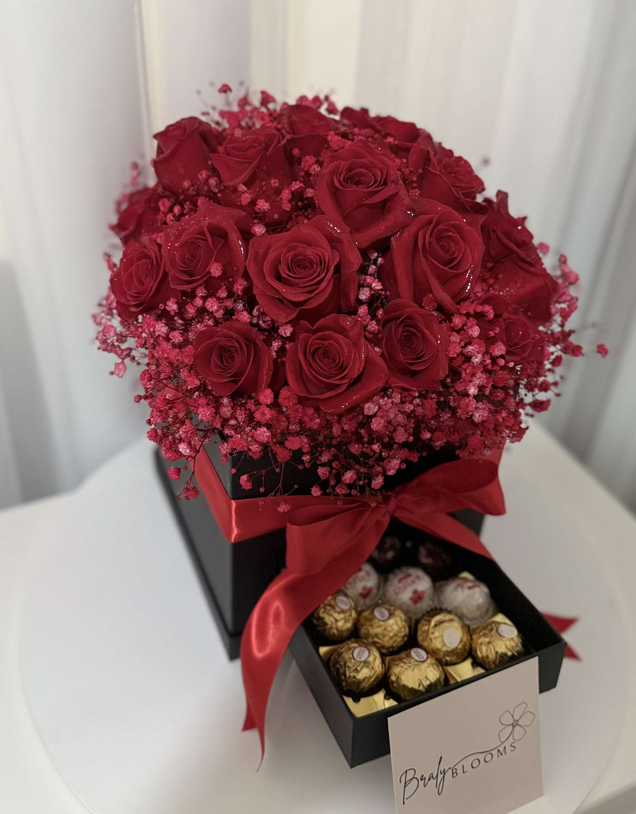 The Grand Romance Box - An elegant box filled with rich red roses at their peak, finished with a sweet surprise drawer of Ferrero Rocher chocolates beneath. A timeless expression of love, passion, and thoughtful luxury—perfect for Valentine's Day,  birthdays, anniversaries, proposals, or unforgettable moments.