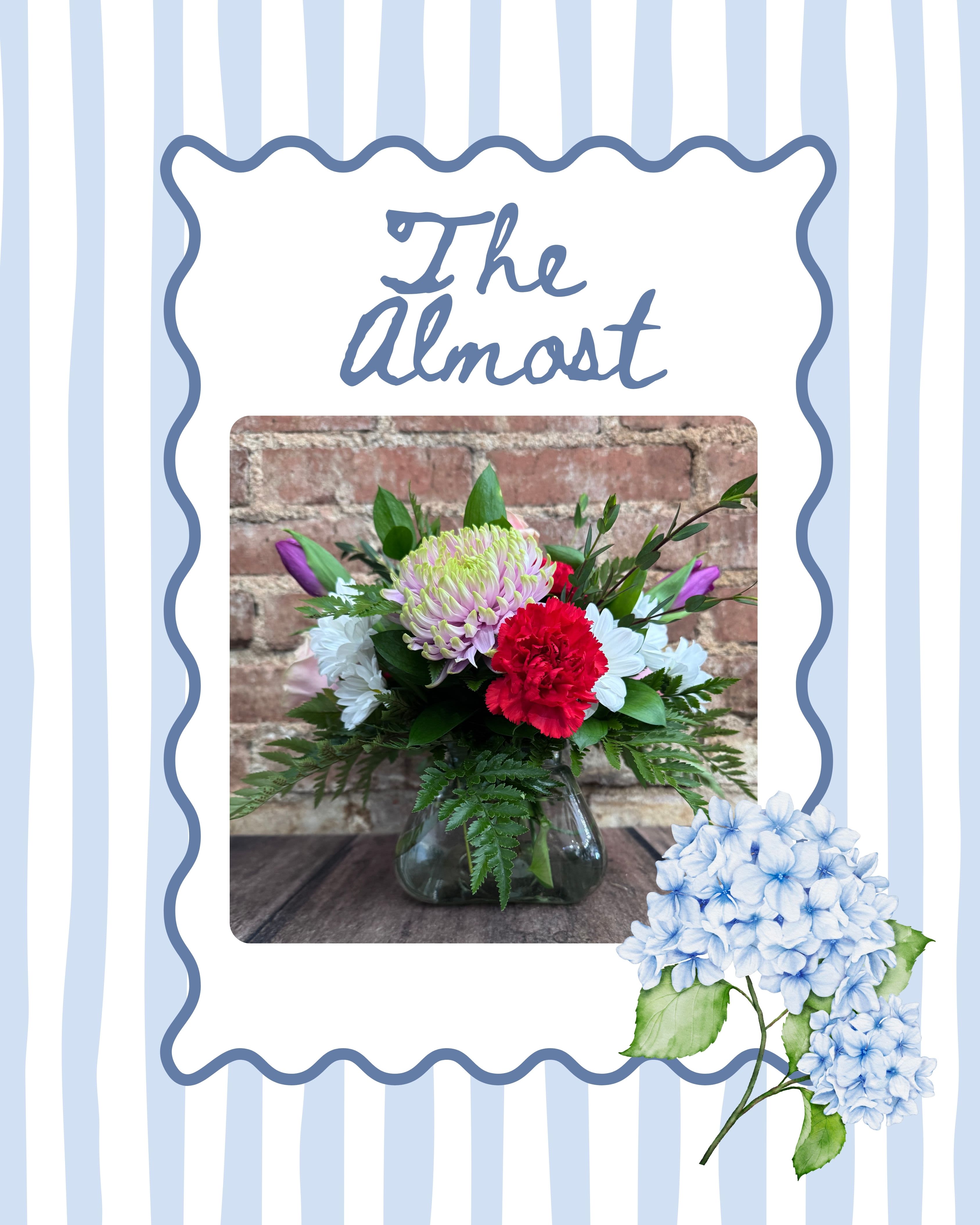 The Almost - The Almost is a small square arrangement featuring a curated mix of florist-choice seasonal blooms and fresh greenery. Designed low and compact in a modern glass container, it’s simple, thoughtful, and full of charm. Perfect for desks, bedside tables, or a small but meaningful gesture.