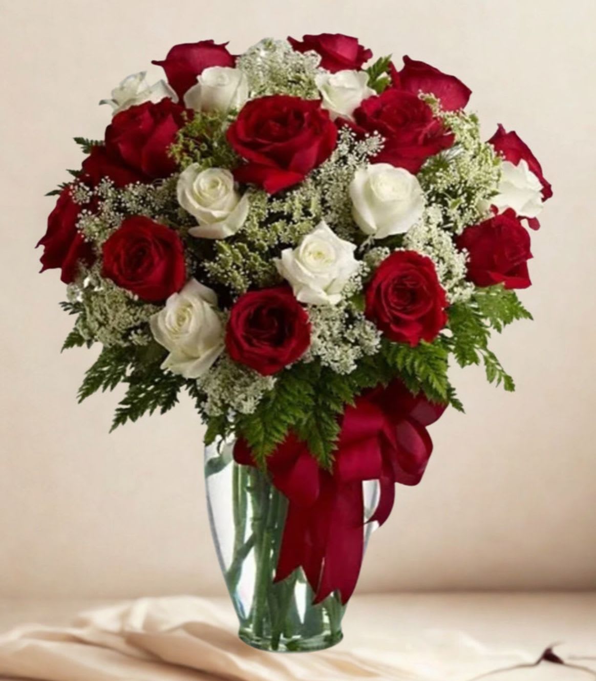Wonder Wishes - A very elegant display of roses in a clear vase to show you care.