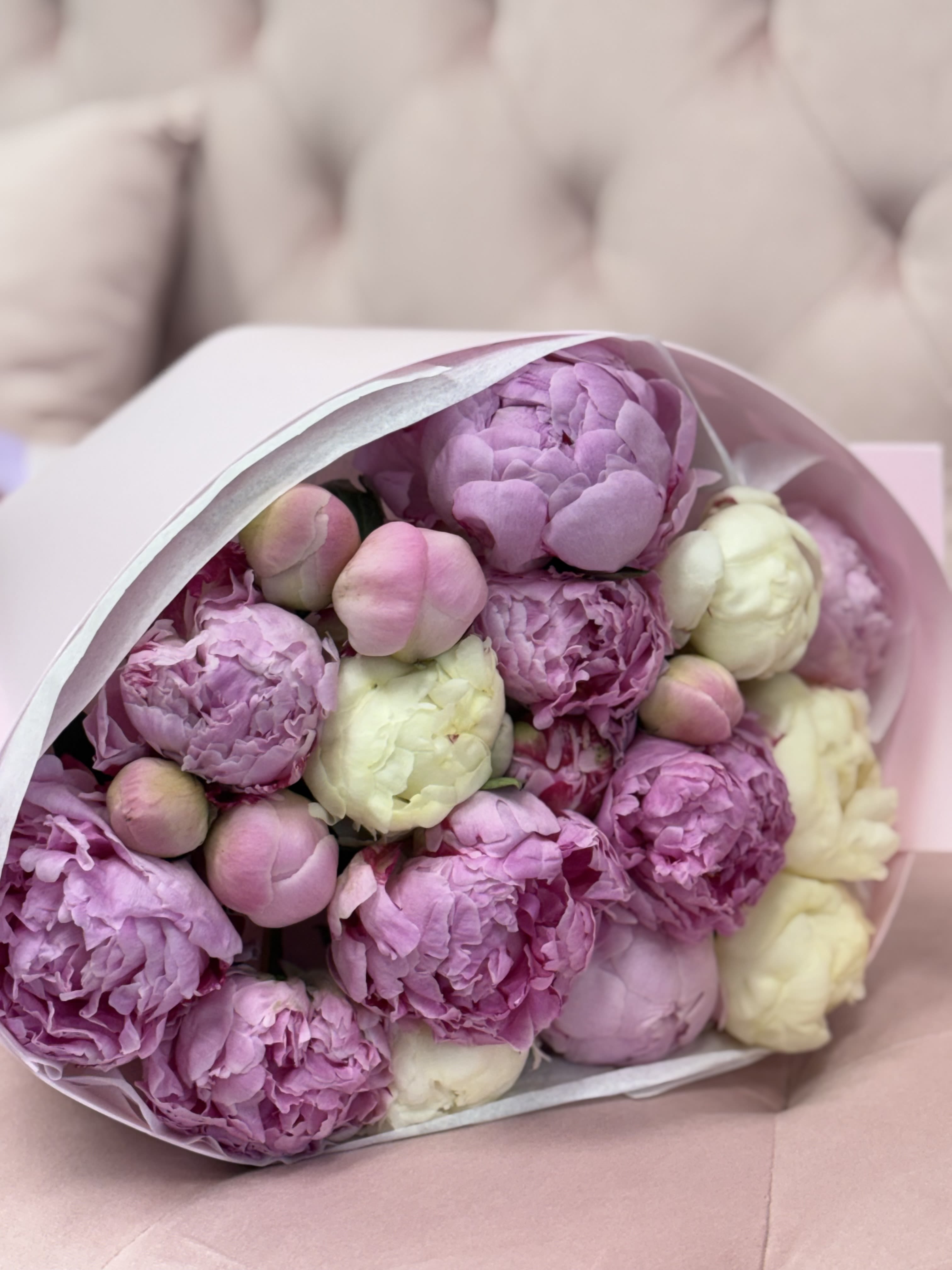 Blush Peony Dream - A luxurious bouquet of premium peonies (20 stems) in soft blush pink, lavender, and creamy white tones. Each bloom is hand-selected at its most beautiful stage, creating a full, airy, and incredibly romantic arrangement. Wrapped in elegant pastel paper and finished with silky ribbons, this bouquet feels like a gentle hug and a timeless expression of love.  Perfect for birthdays, anniversaries, Mother’s Day, or simply to say “you mean everything to me.” Peonies are a symbol of romance, prosperity, and happiness — making this bouquet unforgettable from the very first glance.   Available for local delivery and pickup.
