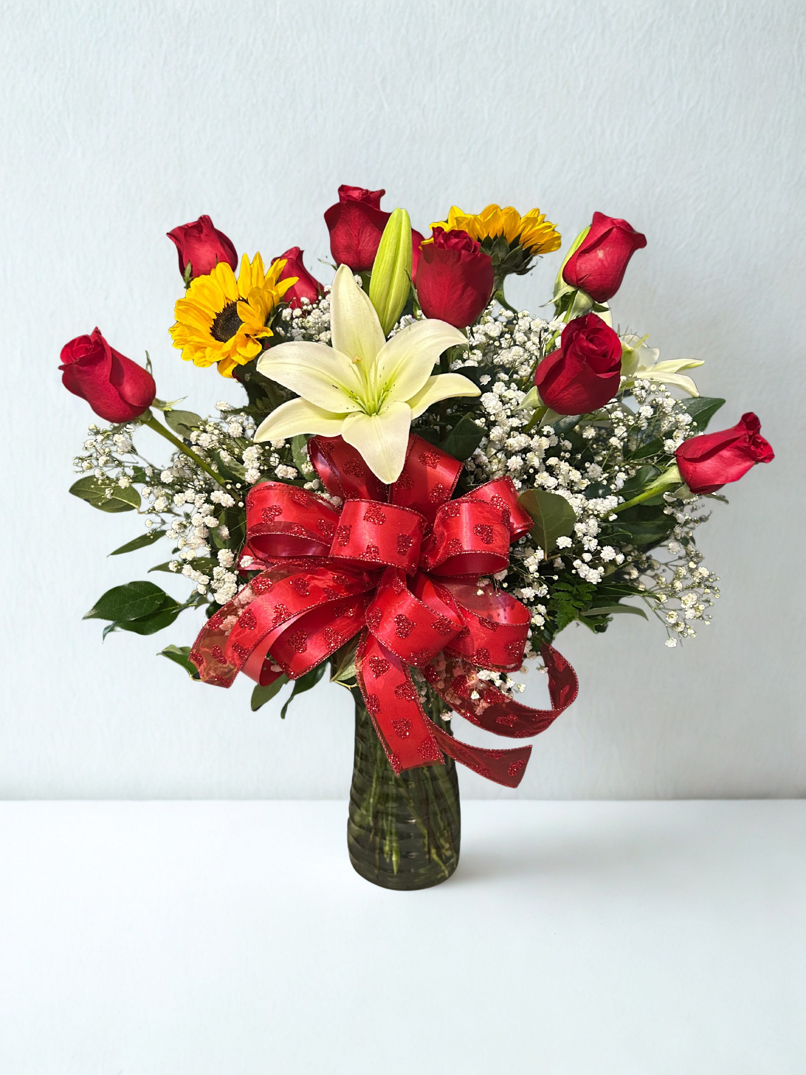 Honey Pot - One dozen red roses, sunflowers, lilies, bells of ireland.
