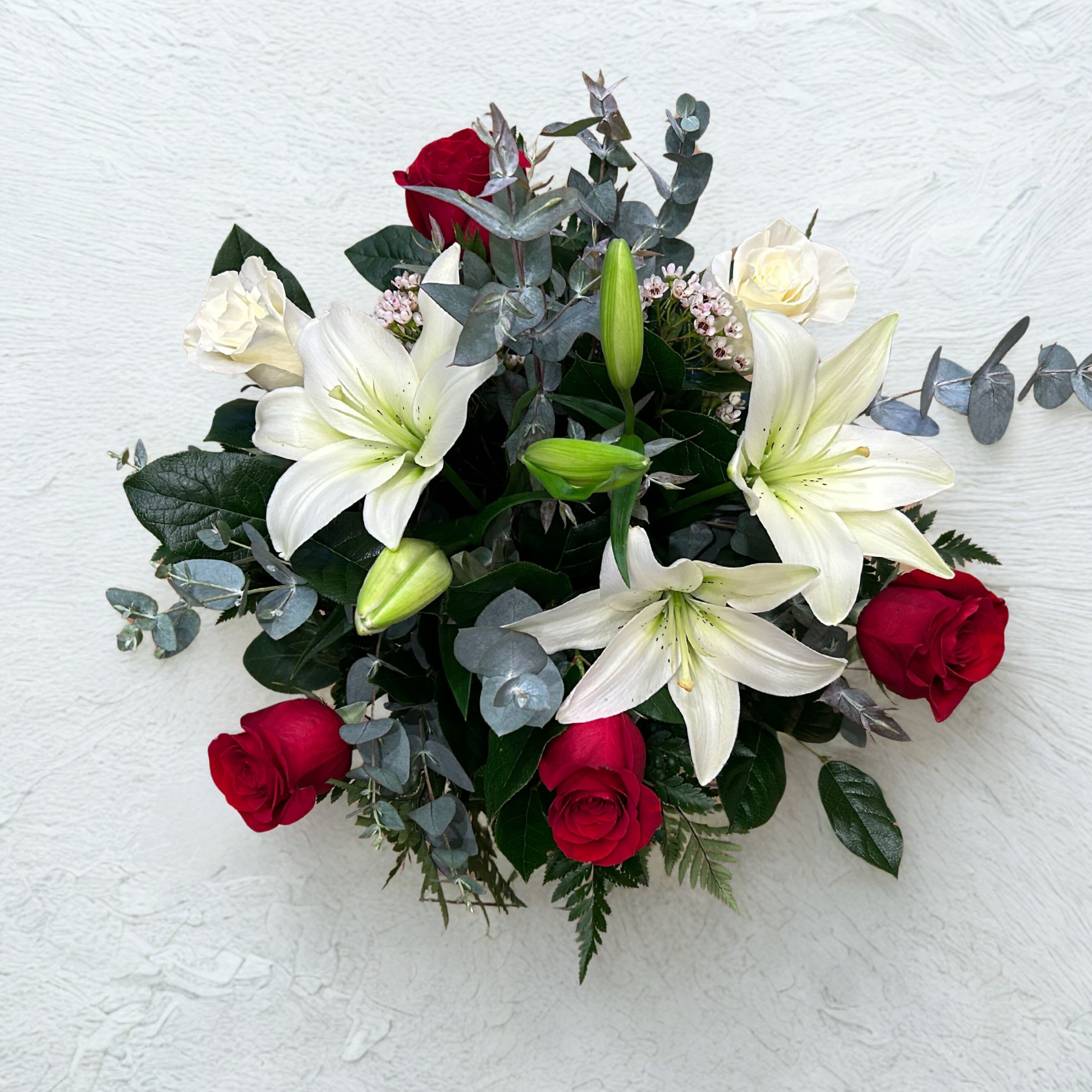 Sorellina Bouquet - Crafted with vibrant red roses, pristine white roses, and graceful white lilies. *this does not come with a vase, if you want a vase, please add one to your cart