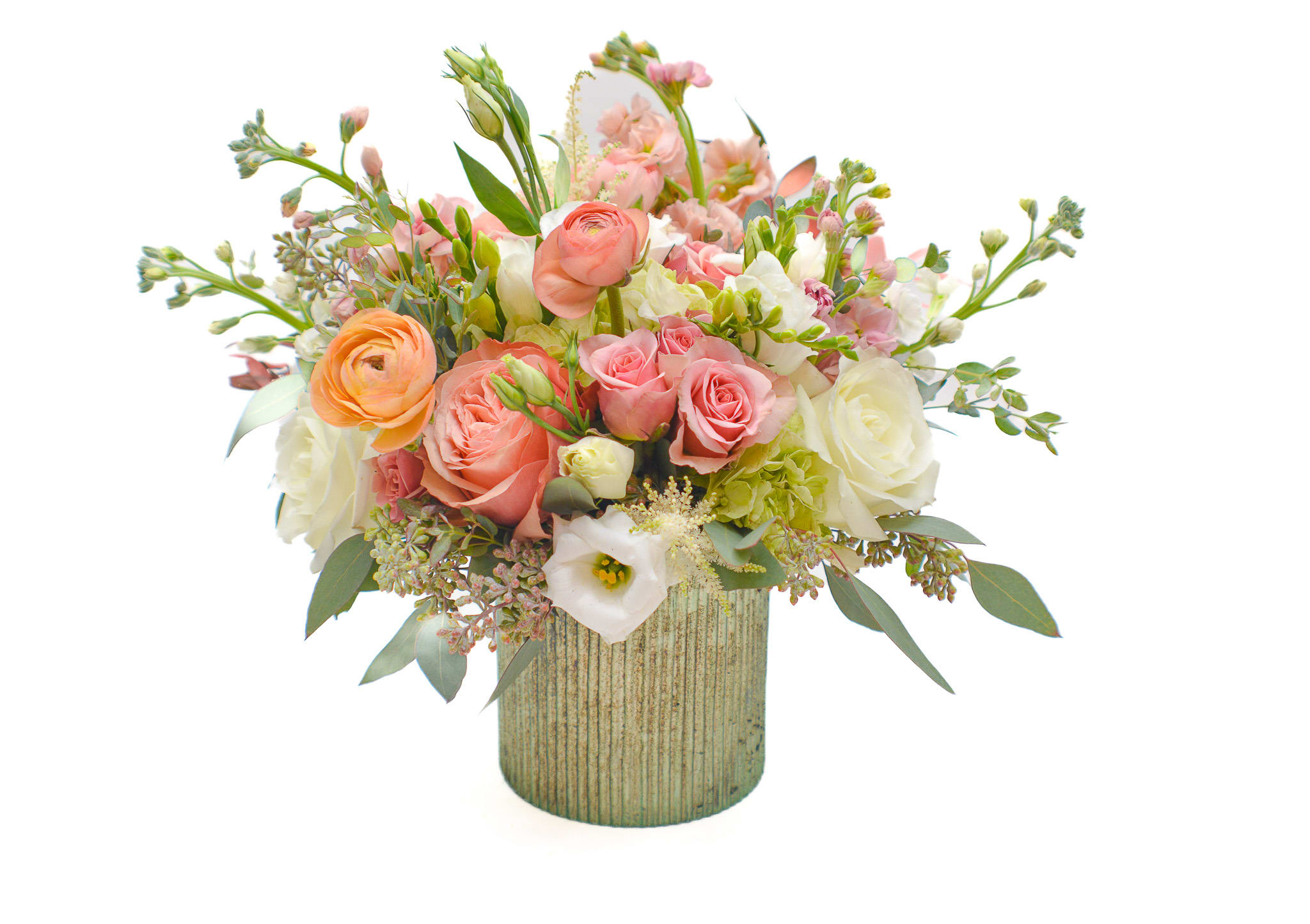 Honor - Delicate and sweet, combination of shades, peach and white. This bouquet features lush peach ranunculus, sweet roses, spray roses and stunning white lisianthus and freesia. Peach flowers symbolize spring, feminine charm, softness and purity.  Comes in a beautiful light green vase.