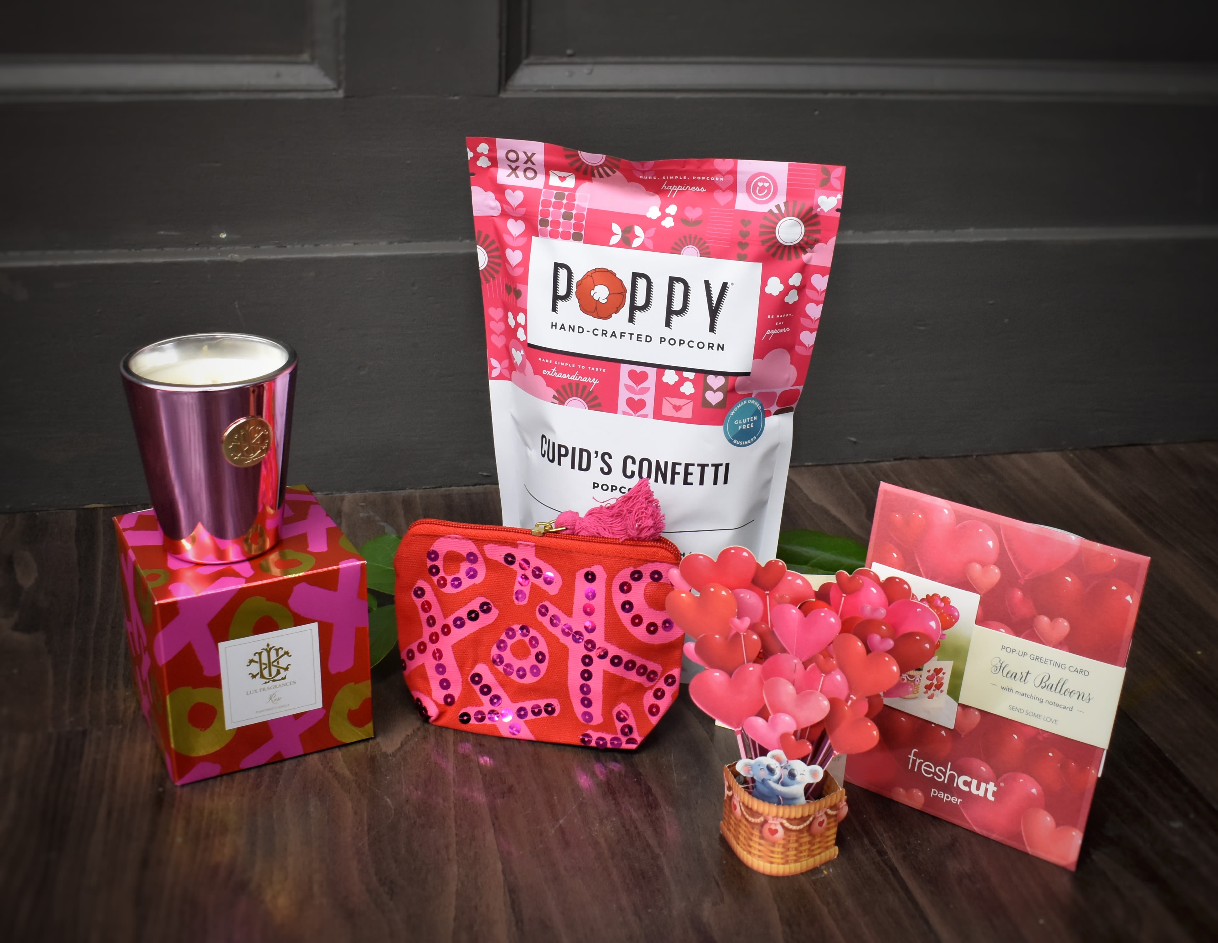 Cupid's Gift Bundle  - A gift set from Cupid himself! This bundle includes Poppy's Valentine's Day popcorn (caramel popcorn with a raspberry infused chocolate drizzle), a luxurious candle, a keepsake pop-up card, and a versitile XO pouch all presented in a gift bag. 