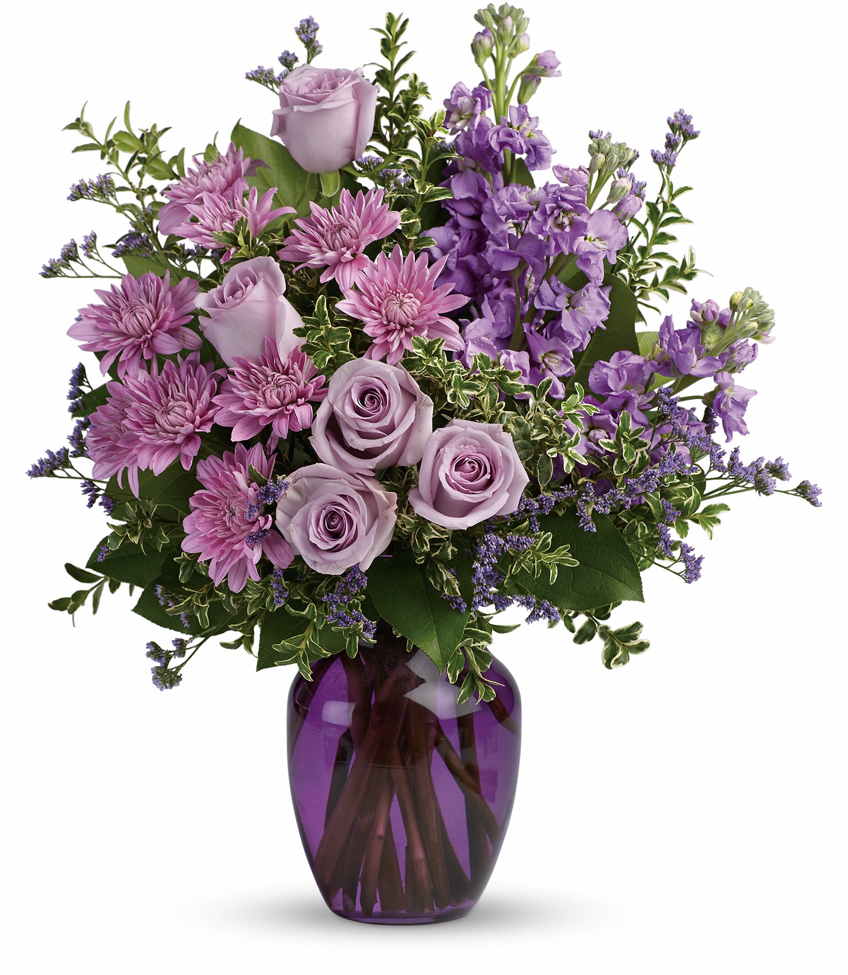 Together at Twilight - Capture the magic of togetherness with this bountiful bouquet of enchanting lavender roses. Artfully arranged in a glass vase, its twilight hues are sure to brighten anyone's day!  This dramatic arrangement includes lavender roses, lavender stock, lavender cushion spray chrysanthemums, lavender limonium, oregonia and lemon leaf. Delivered in a purple glass vase. Approximately 15 3/4" W x 18 1/4" H 