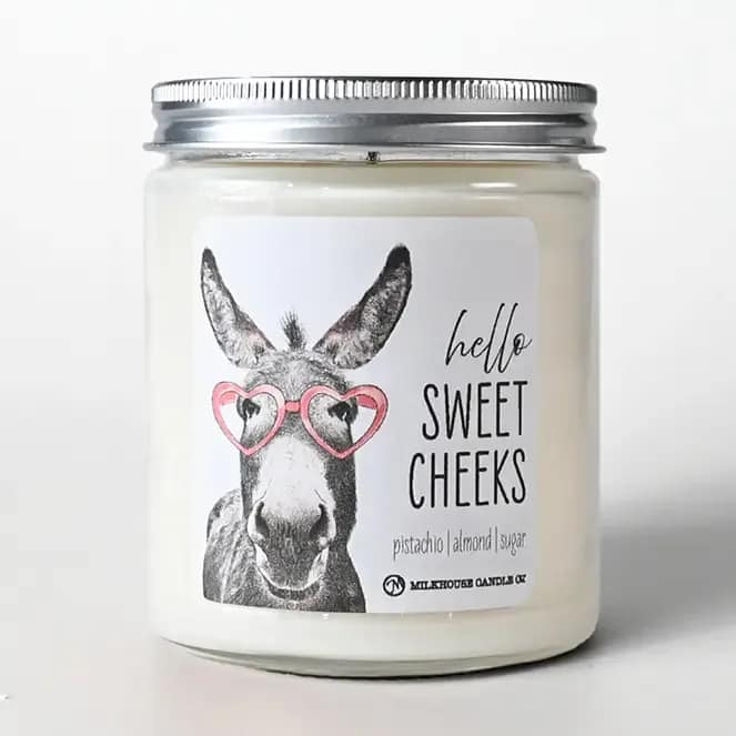 Sweet Cheeks Valentine Candle  - Playful, sweet, and full of personality, our 'Hello Sweet Cheeks' Candle is a customer favorite for lighthearted gifting. This dessert-inspired fragrance blends nutty pistachio, warm almond, and sugary sweetness for a cozy, comforting scent that feels indulgent without being overpowering. 