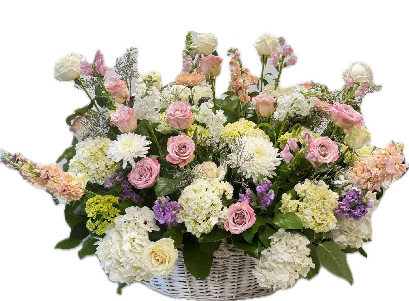 Graceful Farewell Basket - Graceful Farewell is a mix of warm and cool pastel Spring colors to evoke soft comfort in memory of a warm spirit. Featuring mini green hydrangeas, cream roses, soft yellow stock, light pink roses, buttery spray roses, light blue delphinium, lavender stock, and tulips.  This arrangement is thoughtfully designed using the freshest flowers available for the season. While the overall look and palette will be honored, specific flowers may vary. Advance notice is required for funeral arrangements due to the scale of these designs.