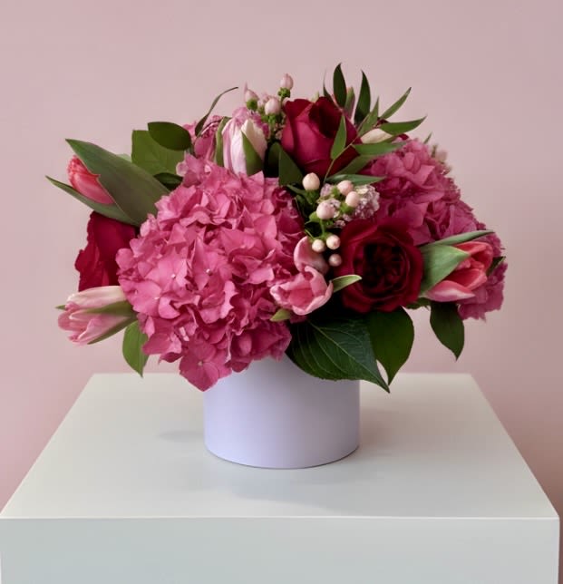 P.S...I Love You - This vibrant beautiful arrangement of hydrangea, roses, tulips and hypericum would make anyone feel loved.