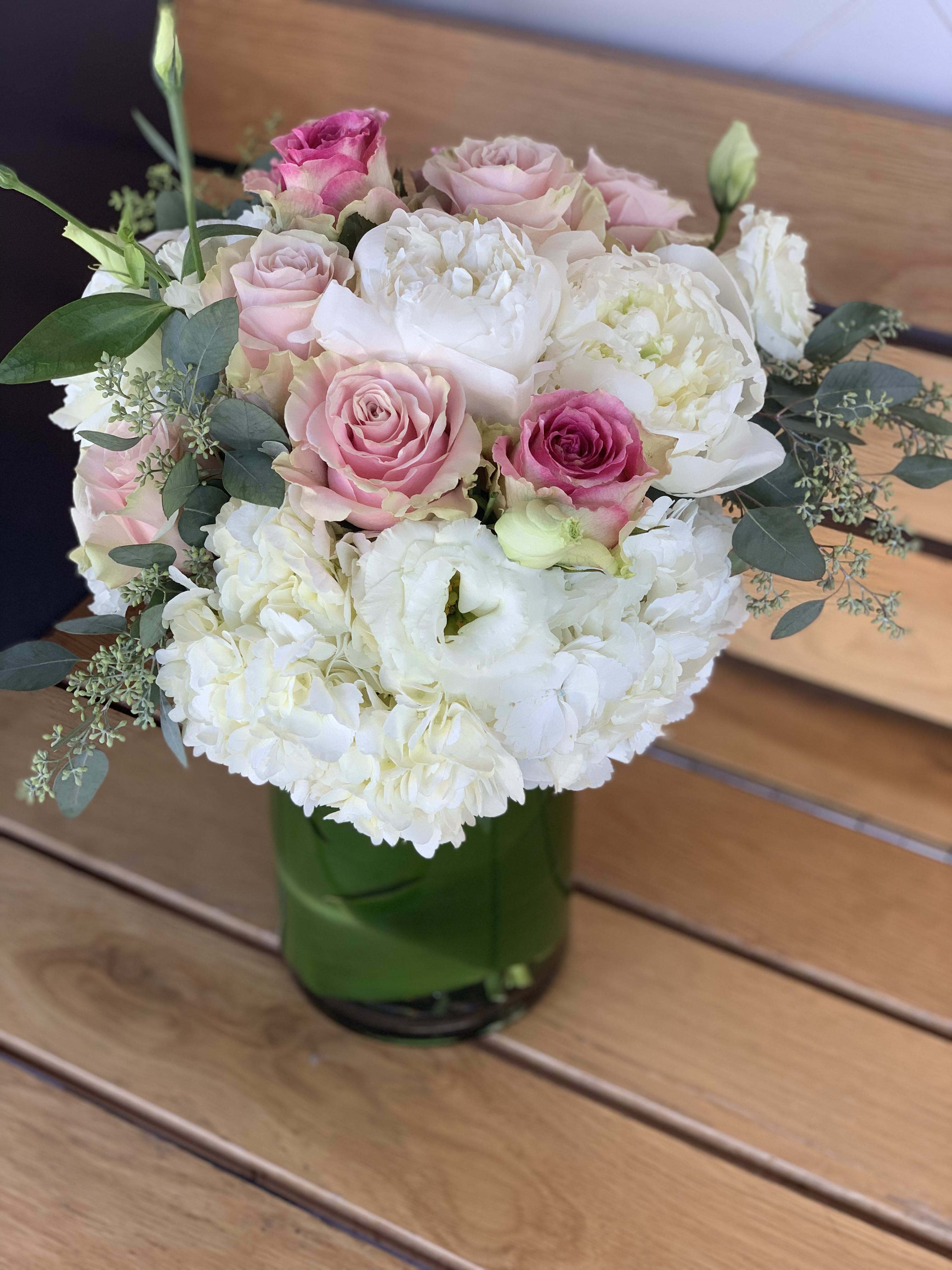 Blush Pinks - Pretty shades of pink roses arranged with hydrangeas, peonies, lisianthus and touch of greens.