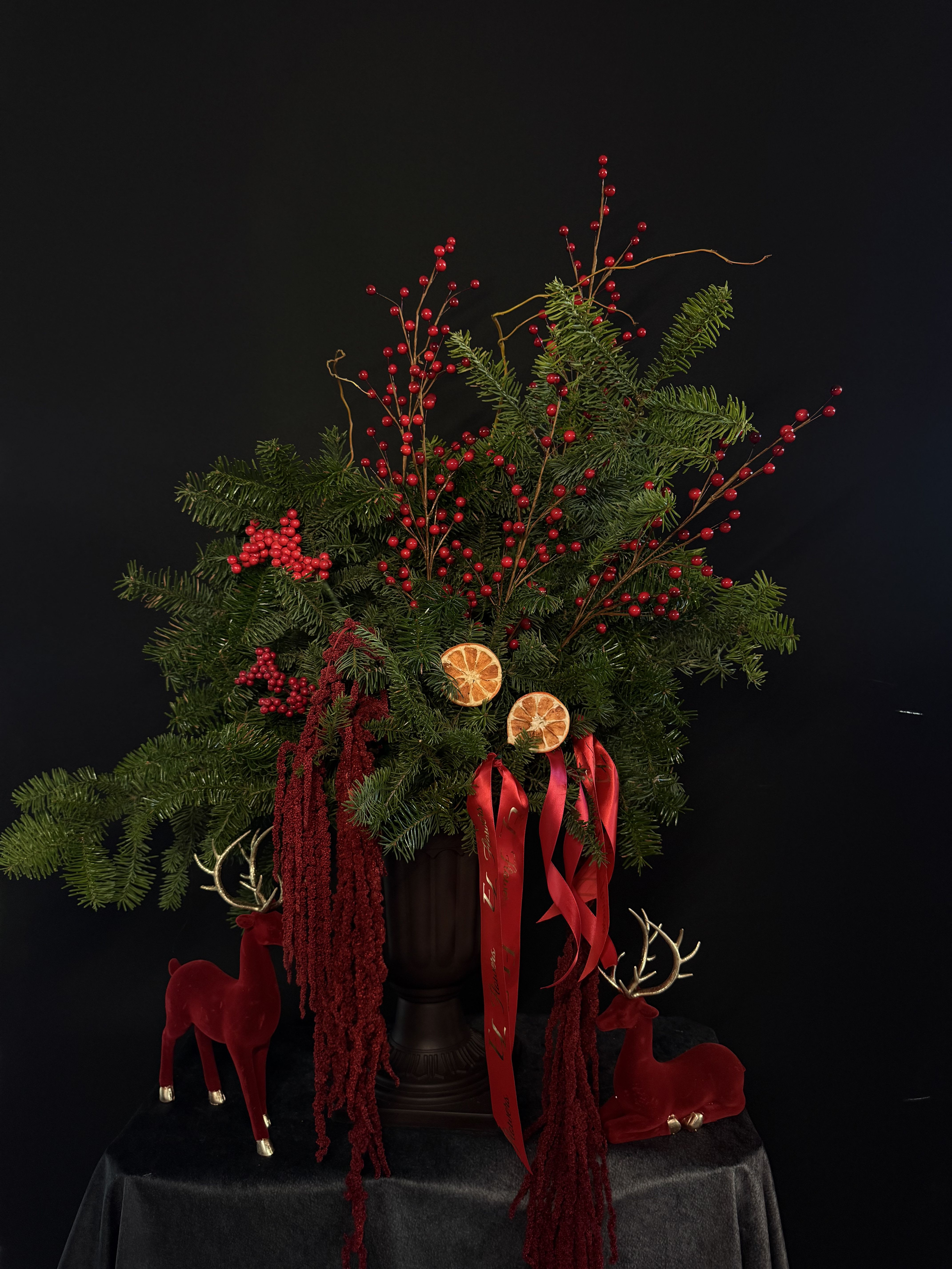 Luxury Christmas Arrangement – Red &amp; Evergreen Edition  - A stunning holiday centerpiece designed to bring instant Christmas magic into any home. Created with fresh evergreen branches, vibrant winter berries, velvet-soft accents, dried orange slices, and rich red ribbons — all arranged in a classic pedestal vase for an expensive, festive look.