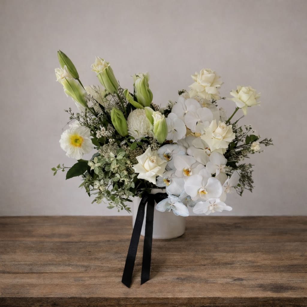 Aura  - White and green arrangement in a white vase 