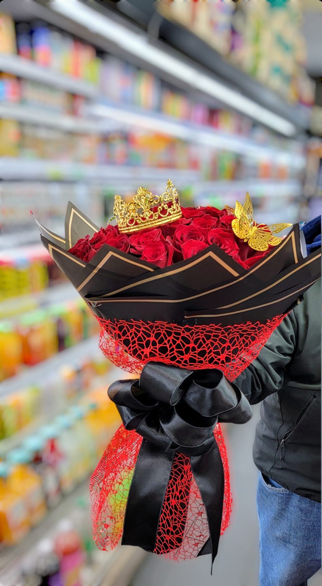 Fateful Love - This bouquet is one of the best ways to say I love you. It is made up of red roses, topped with a gold crown, and golden butterflies. It is all wrapped up in black paper and red fabric and tied off with a beautiful big black bow.