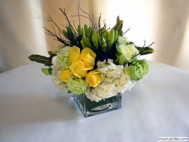 Compact Pave with Roses, Lilies and Hydrangea - Compact pave with clusters of roses, lilies and hydrangea and varragated greens. Dimensions: 12-16 in height, 12-16 in diameter.