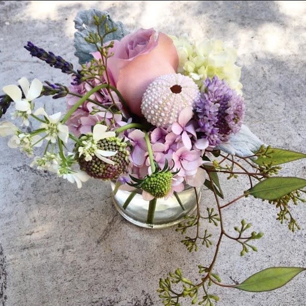 Ariana arrangement - A gorgeous sentiment arrangement in a small 4 by 4" cylinder vase. Perfect to send "just a little something" or for the bedside table, the coffe table or the child. Arranged in seasonal pastel colors with many pretty details. Choose Deluxe for a fuller and larger arrangement placed in a 5 by 5" vase with more flowers. Choose premium for the x-l version of the arrangement with even more flowers placed in a 6 by 6" vase. Blomst LA only uses fresh, high quality flowers, all carefully selected every day to fit your flower order. We offer a personal hand delivery by our own delivery staff and guarantee the flowers will look perfect, when they arrive. We deliver in Glendale, Pasadena, Eagle Rock, Hollywood, Burbank, Beverly Hills and the Pacific Palisades - and everywhere else in Greater Los Angeles.