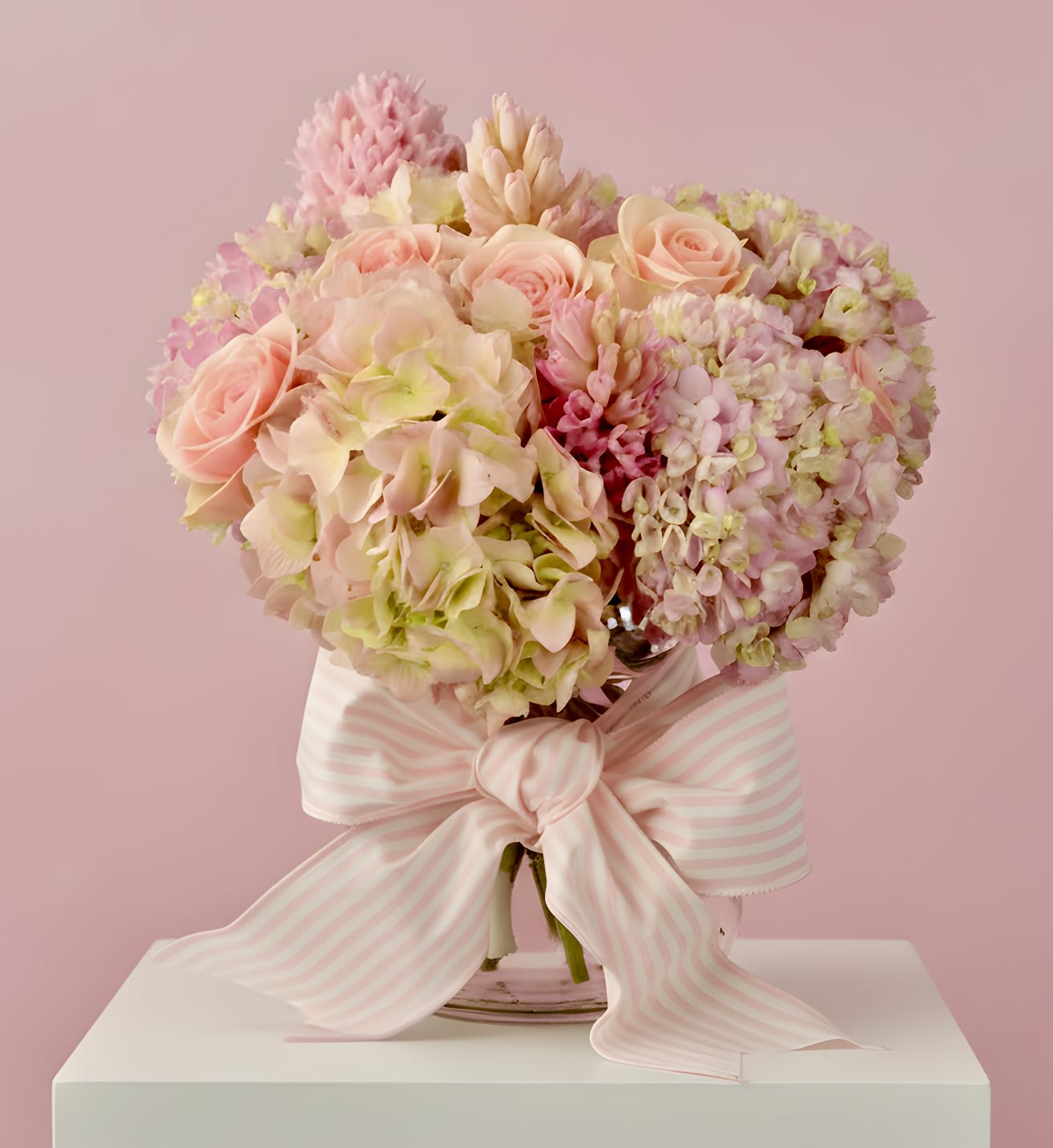 Sweet Baby Girl - The perfect arrangement to welcome a new baby girl. Exact flowers may vary but we will create something special in light baby girl pinks with a cute bow