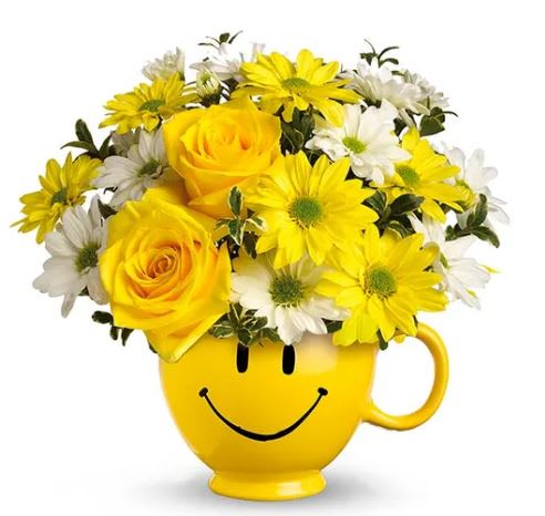 Smiley Face Bouquet - A ceramic mug happy face mug filled with bright yellow roses, white and yellow daisies and green filler. Great idea to brighten any day.