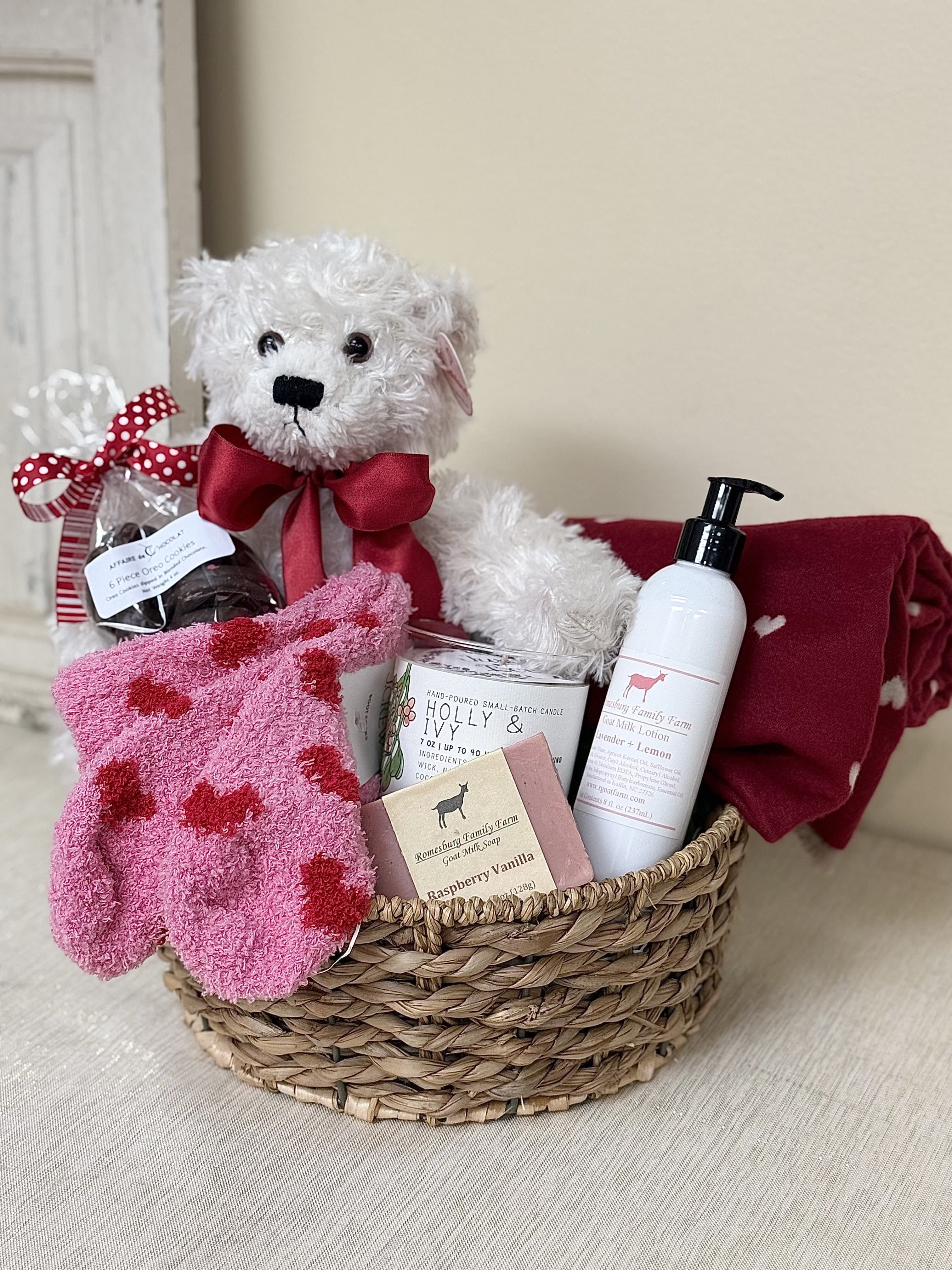 Romantic Basket  - A Romantic Basket, a perfect gift for your special person. We have included a heart blanket, teddy bear, fluffy comfy socks, lotion, soap, a fragrant candle and of course delicious locally made chocolate Oreo cookies.