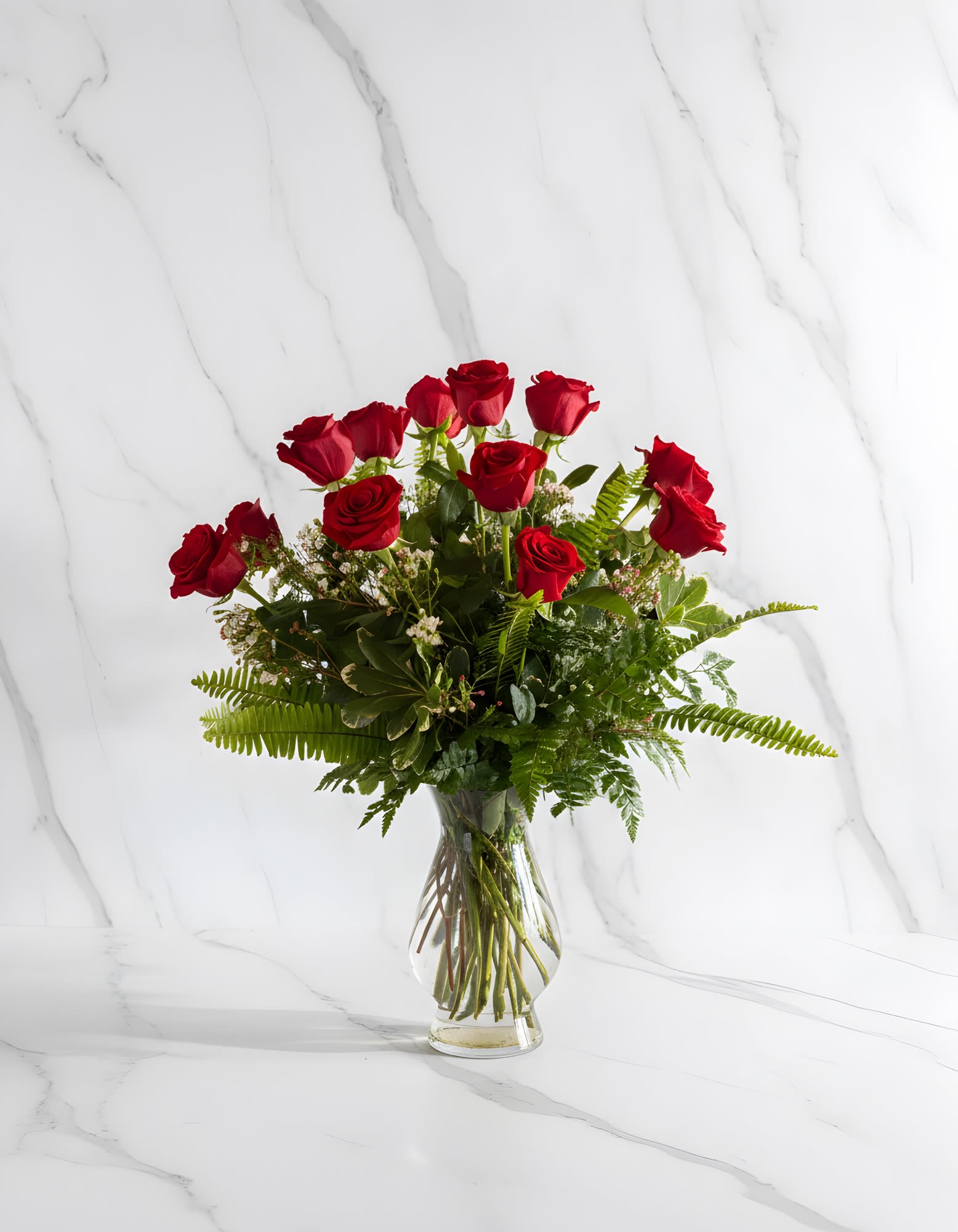The Perfect Dozen  - A dozen roses are always perfect, always savored. We add even more charming beauty with seeded eucalyptus, spiral eucalyptus and salal. Choose your color! Multiple Dozens will be designed in the same vase.